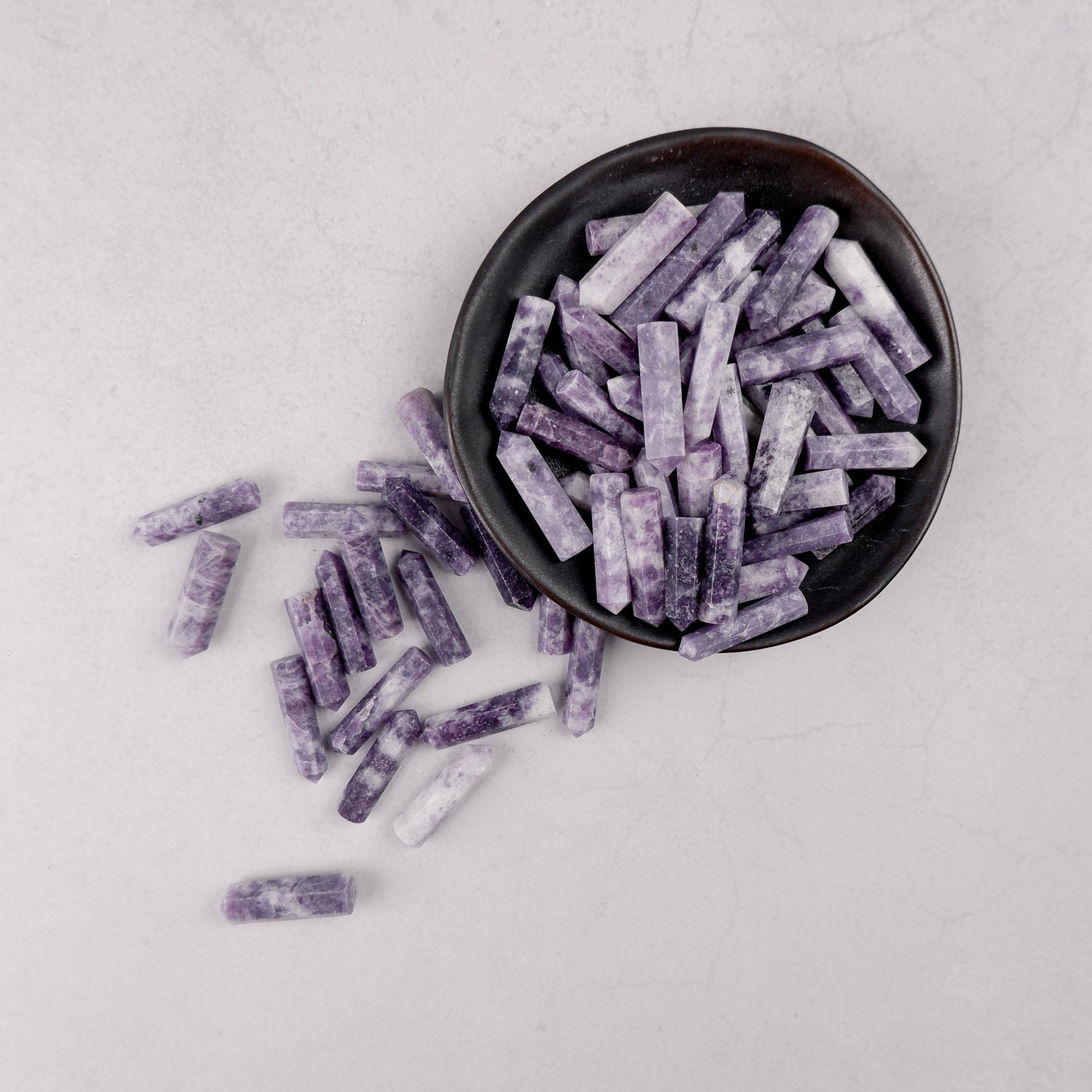 Lepidolite single gridding point from Noctis Studio, showcasing a polished purple mineral crystal with natural striations.