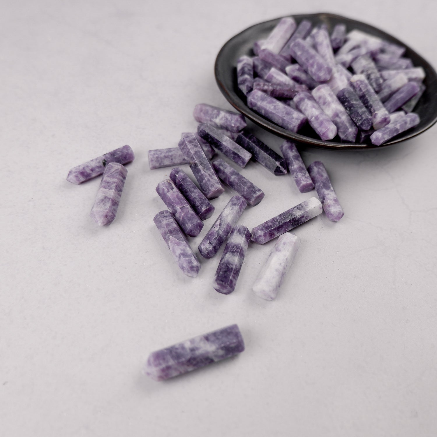 Lepidolite single gridding point from Noctis Studio, showcasing a polished purple mineral crystal used for energy work.