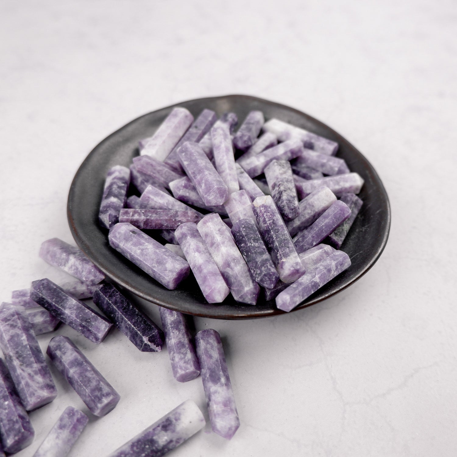 Lepidolite single gridding point from Noctis Studio, showcasing a polished mineral crystal with purple and pink hues.