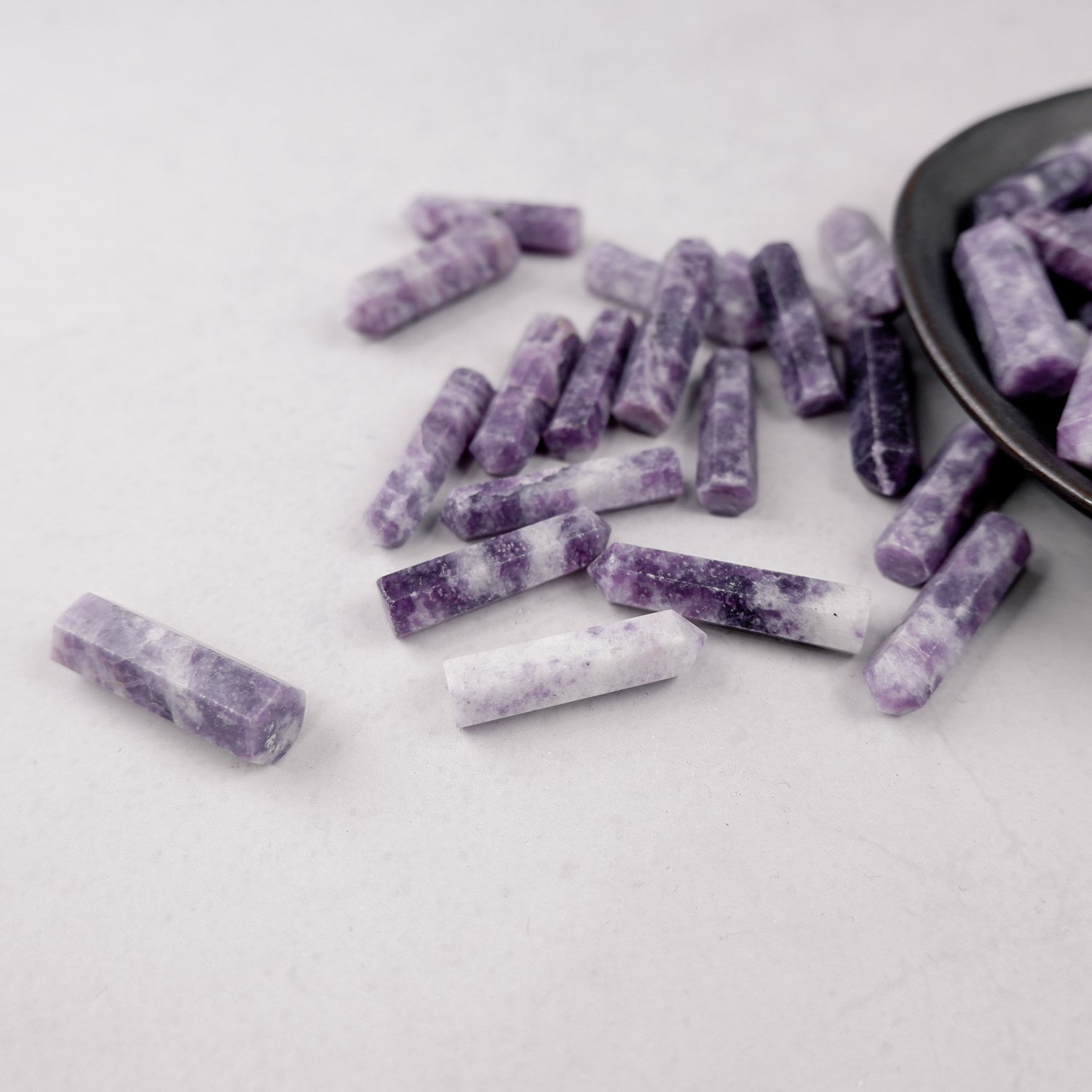 Lepidolite single gridding point by Noctis Studio, showcasing a polished mineral crystal with purple and lilac hues.