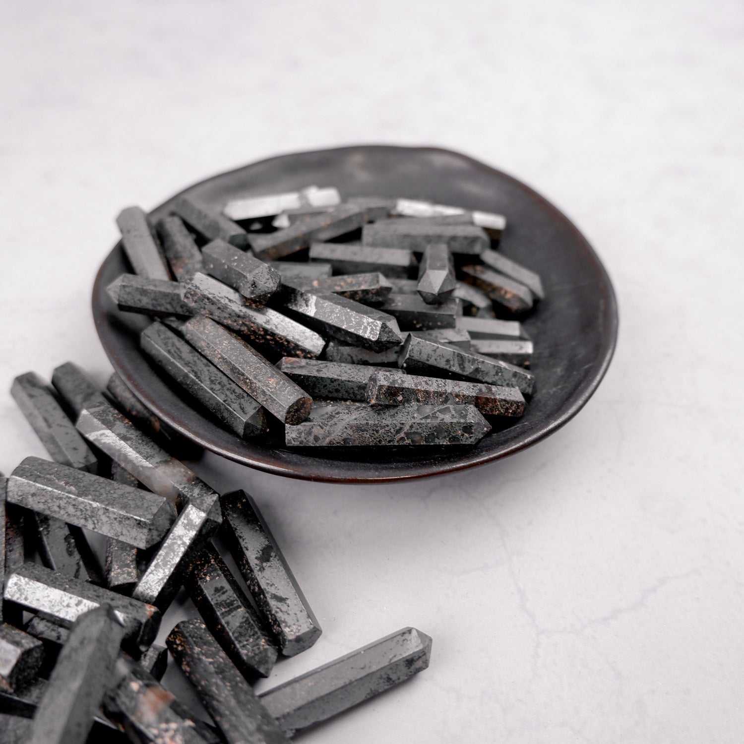 Hematite single gridding point by Noctis Studio, showcasing a metallic tool with a pointed tip for precise gridding applications.