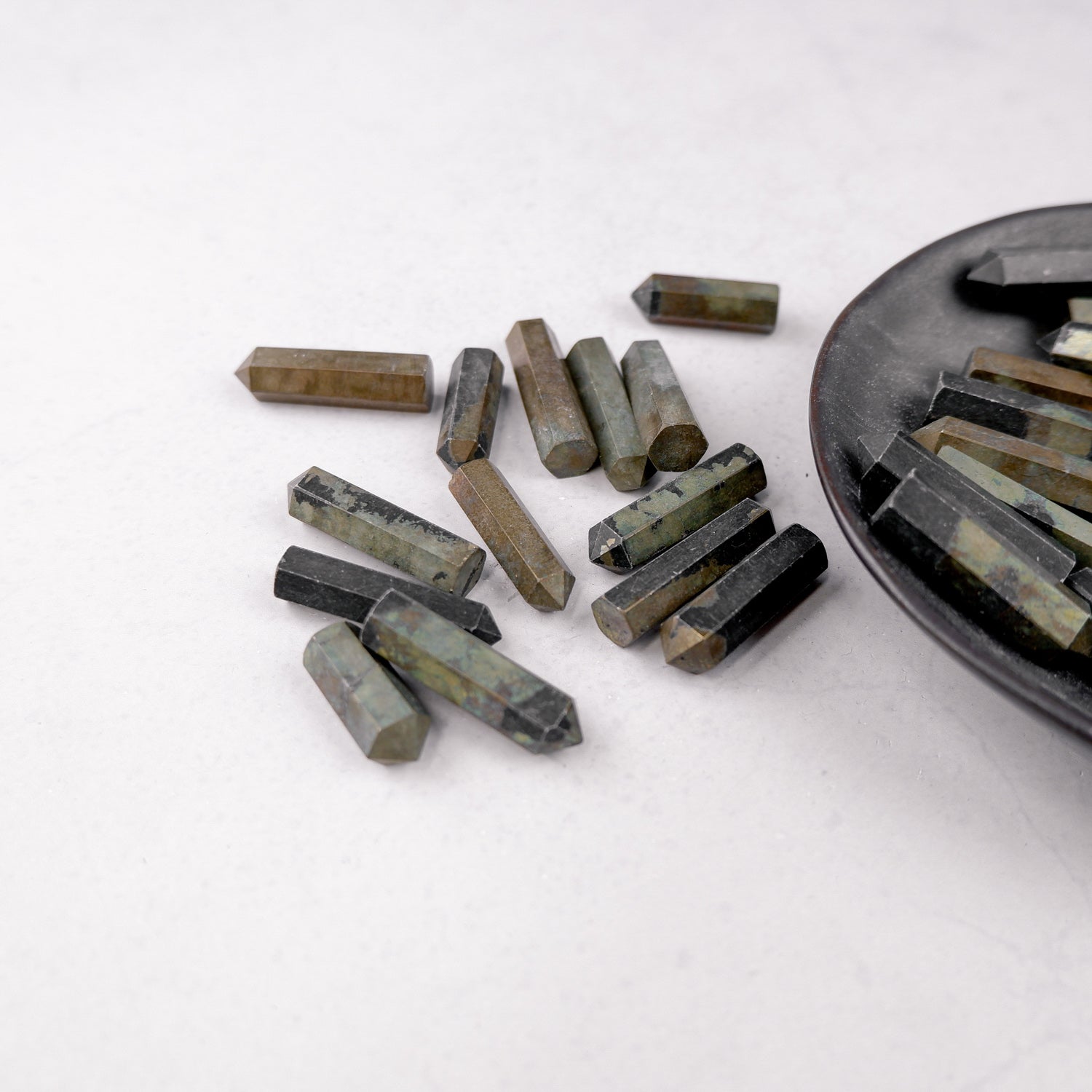 Noctis Studio Pyrite single gridding point with a metallic, geometric design used for crystal healing and energy work.