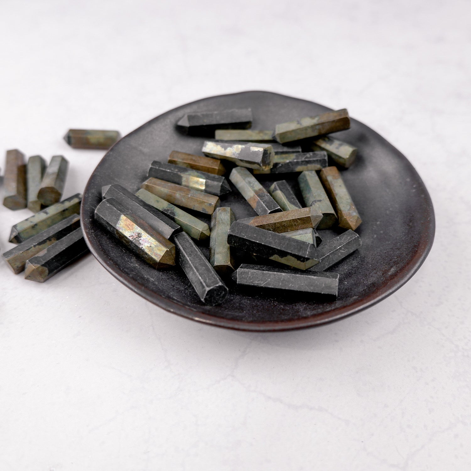 Pyrite single gridding point from Noctis Studio, featuring a metallic gold finish and pointed tip for crystal grid work.