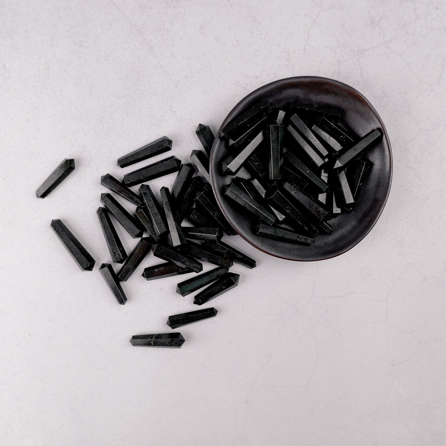 Black Tourmaline double gridding point from Noctis Studio, showcasing polished crystal with pointed ends for energy focusing.