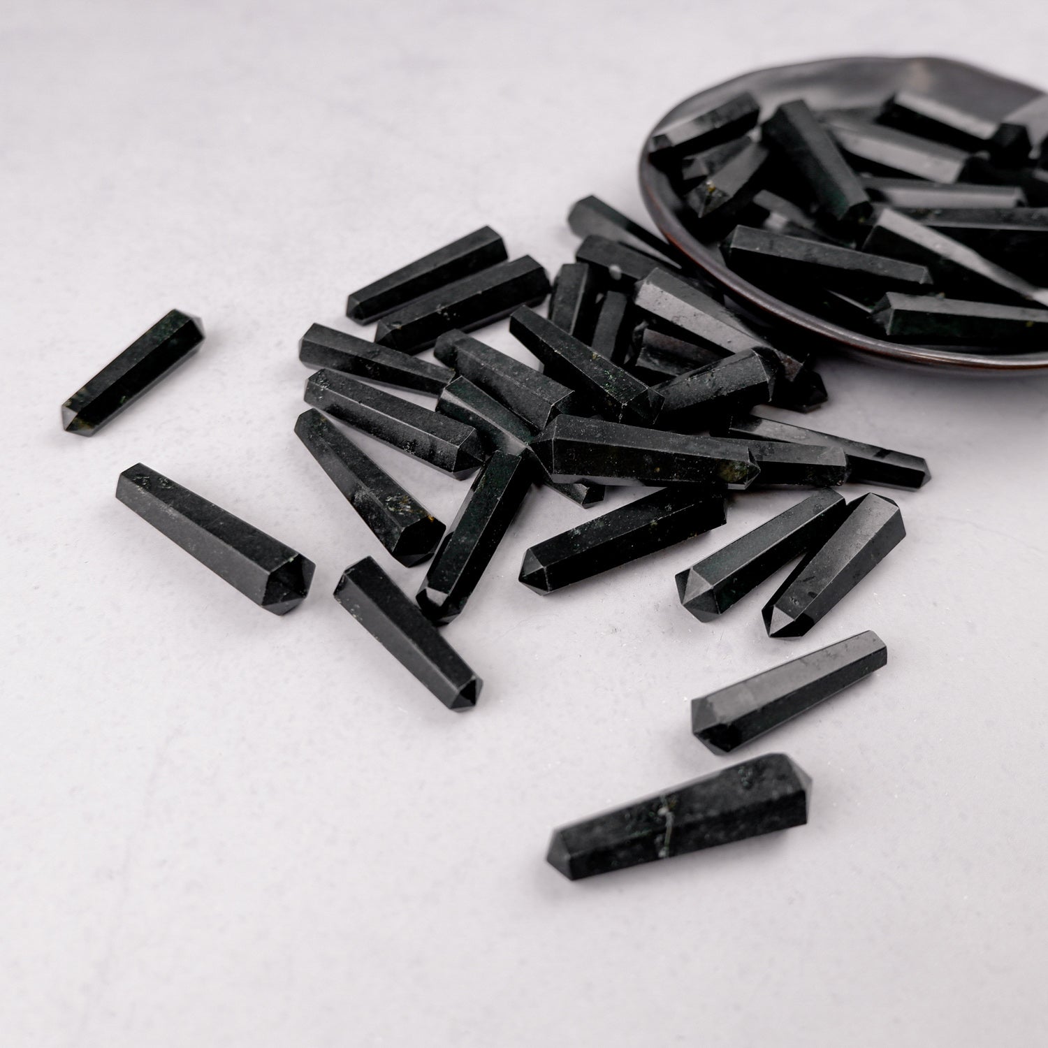 Black Tourmaline double gridding point from Noctis Studio, showcasing a polished stone with pointed ends and natural gemstone details.
