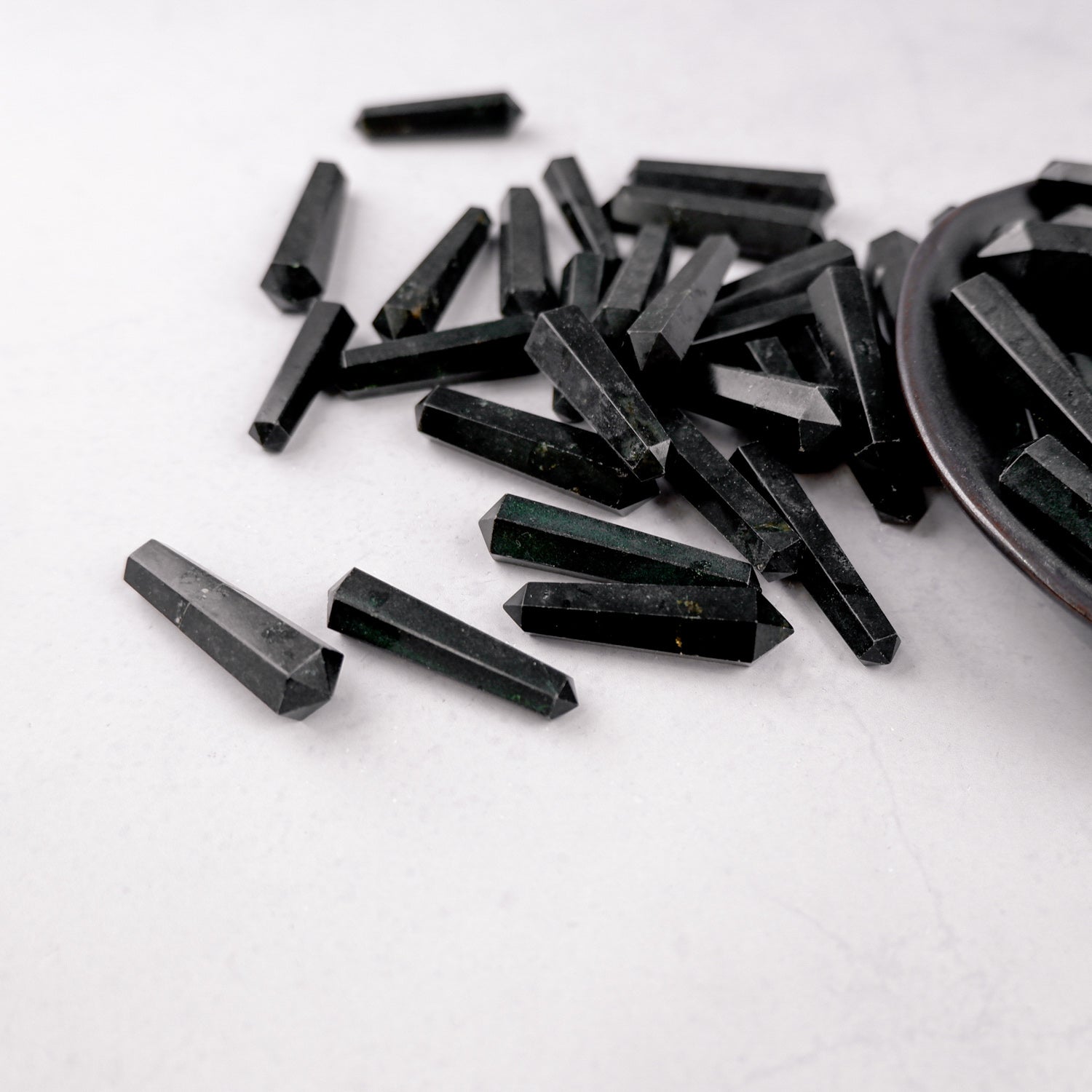 Black Tourmaline double gridding point from Noctis Studio, showcasing polished crystal with natural striations and pointed shape.