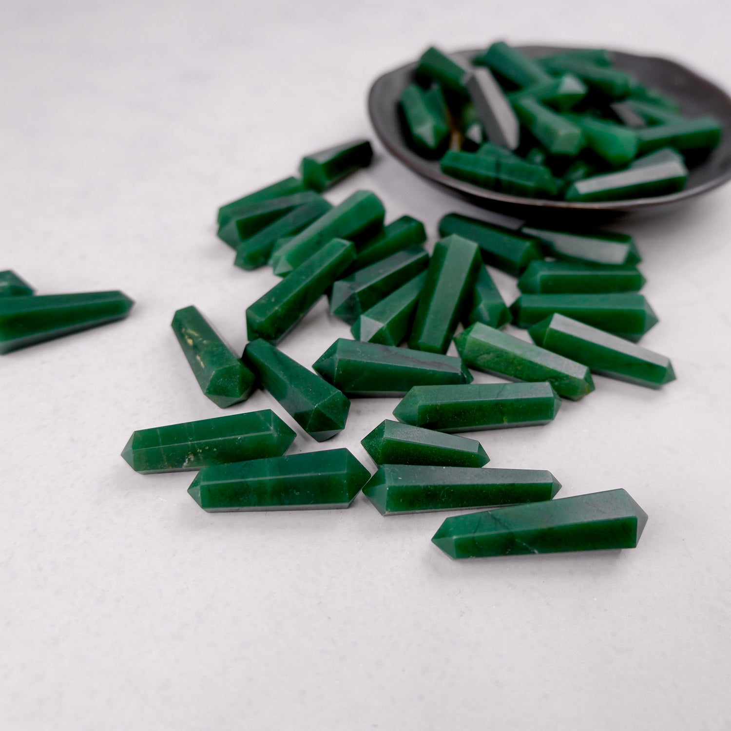 Dark green aventurine double gridding point from Noctis Studio, featuring polished gemstone with pointed tip and intricate design.