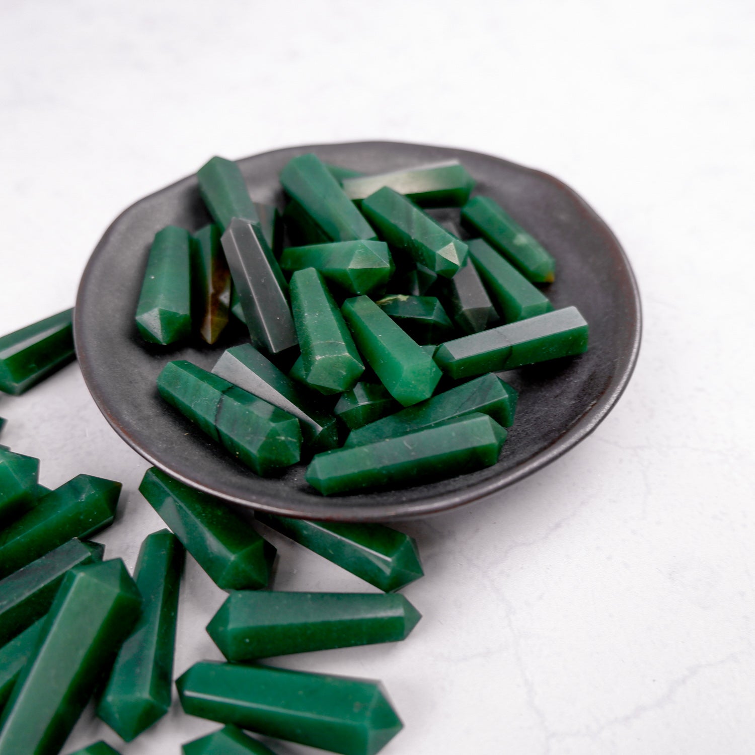 Dark green aventurine double gridding point from Noctis Studio, polished gemstone with pointed tip and intricate details.