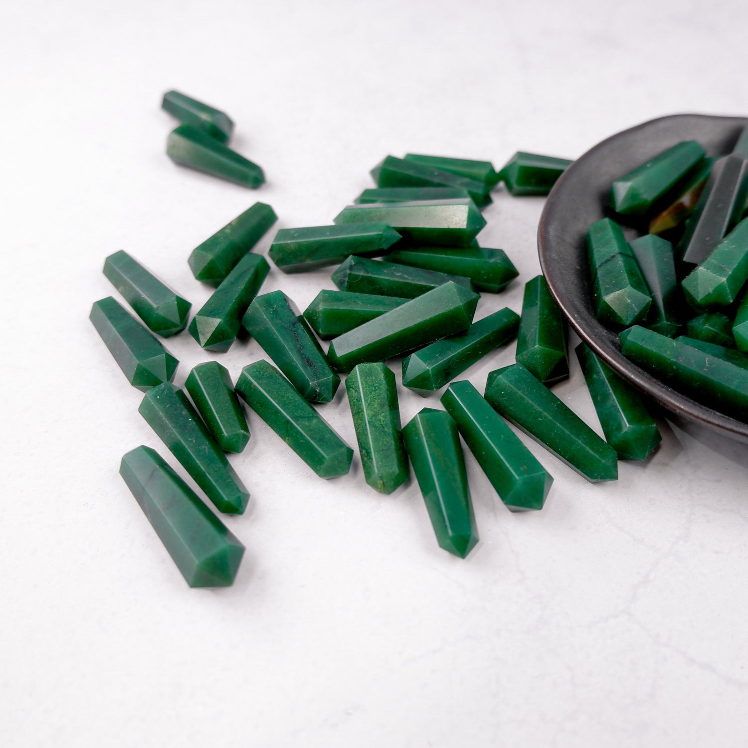 Dark green aventurine double gridding point from Noctis Studio, showcasing polished stone with pointed tip and intricate surface details.