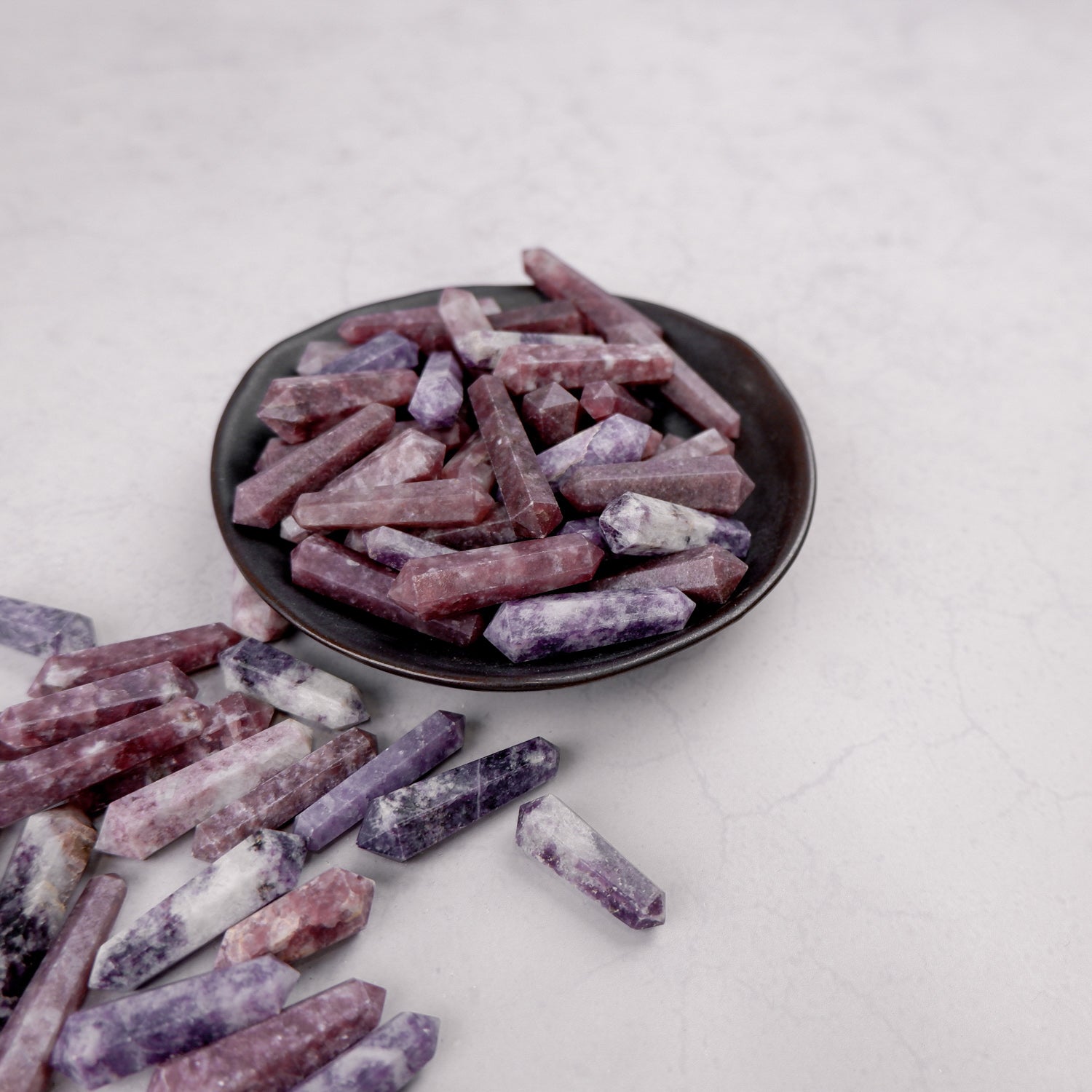 Lepidolite double gridding point from Noctis Studio, showcasing a polished, purple mineral crystal with natural striations.