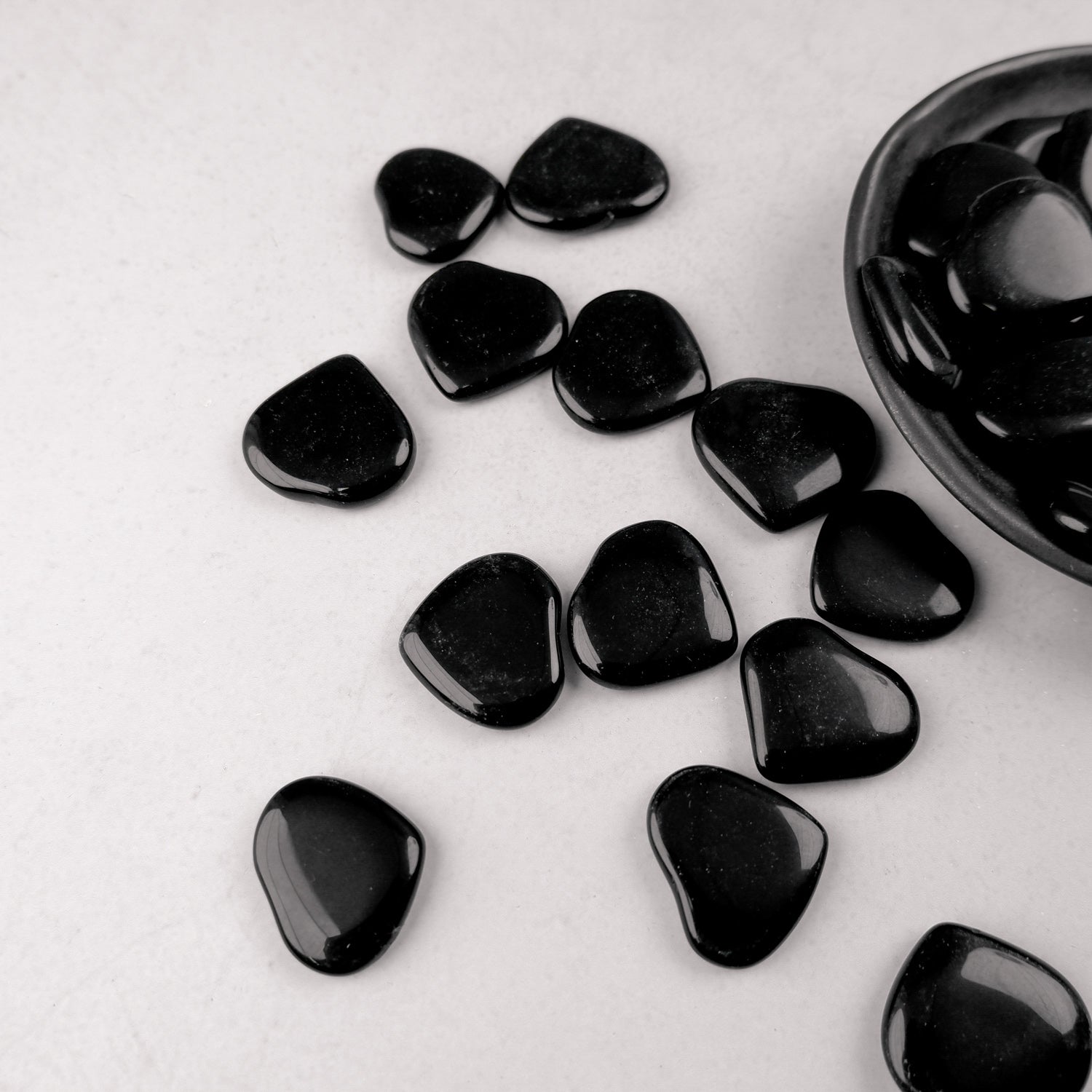Black obsidian heart sculpture by Noctis Studio, smooth polished stone heart with natural glossy finish.