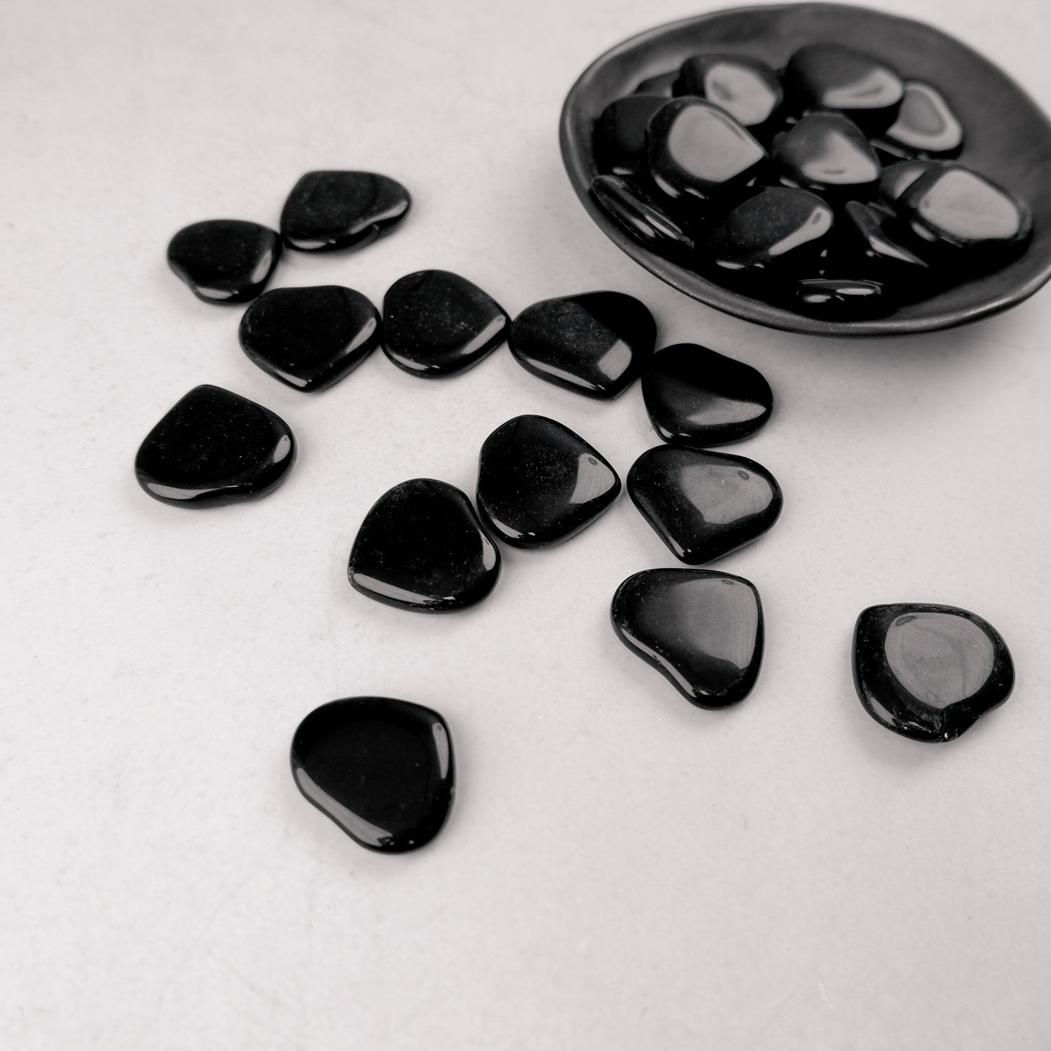 Dark obsidian heart sculpture by Noctis Studio, showcasing smooth, polished stone with a glossy finish and natural deep black color.