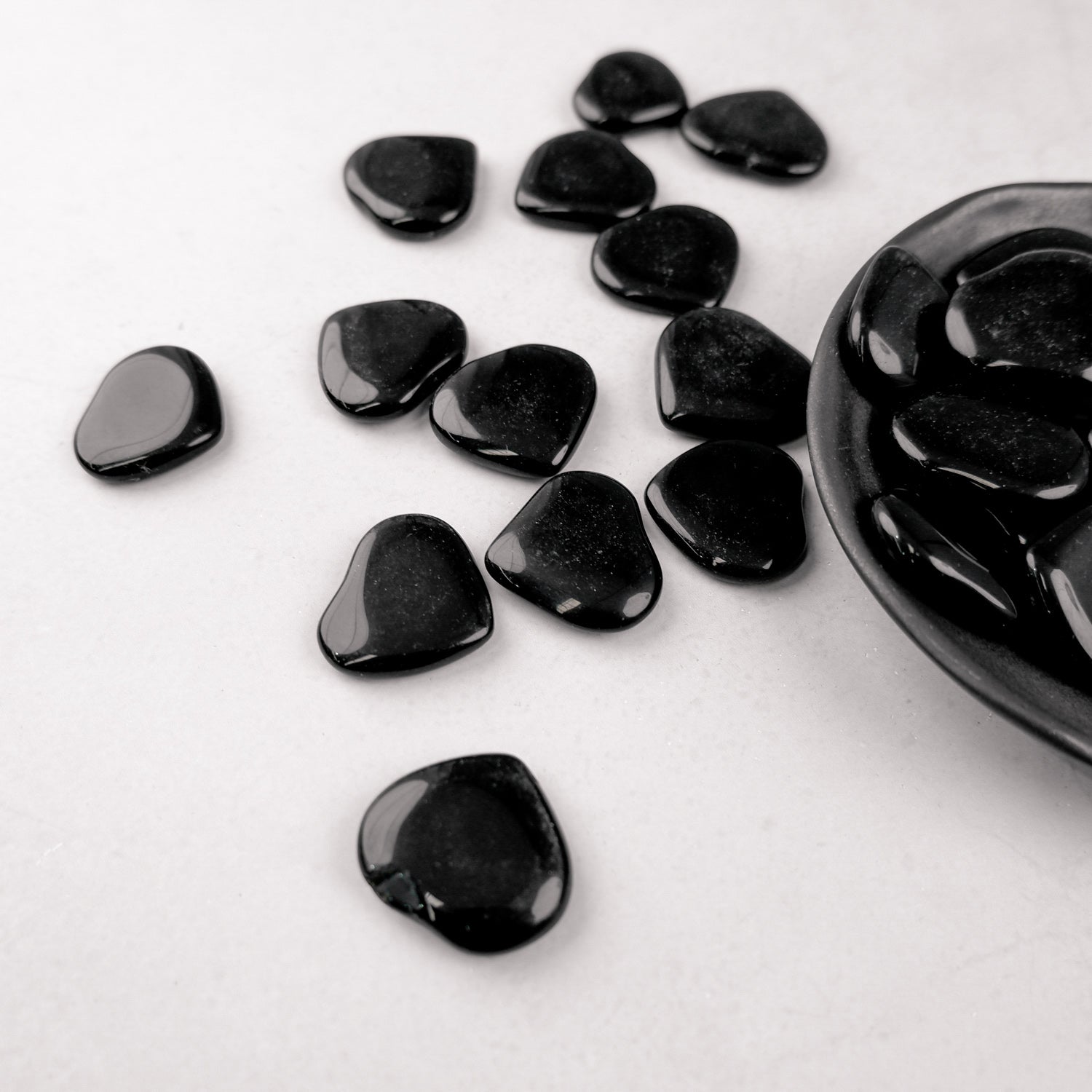 Dark obsidian heart sculpture by Noctis Studio, smooth black stone with polished surface and intricate heart shape.