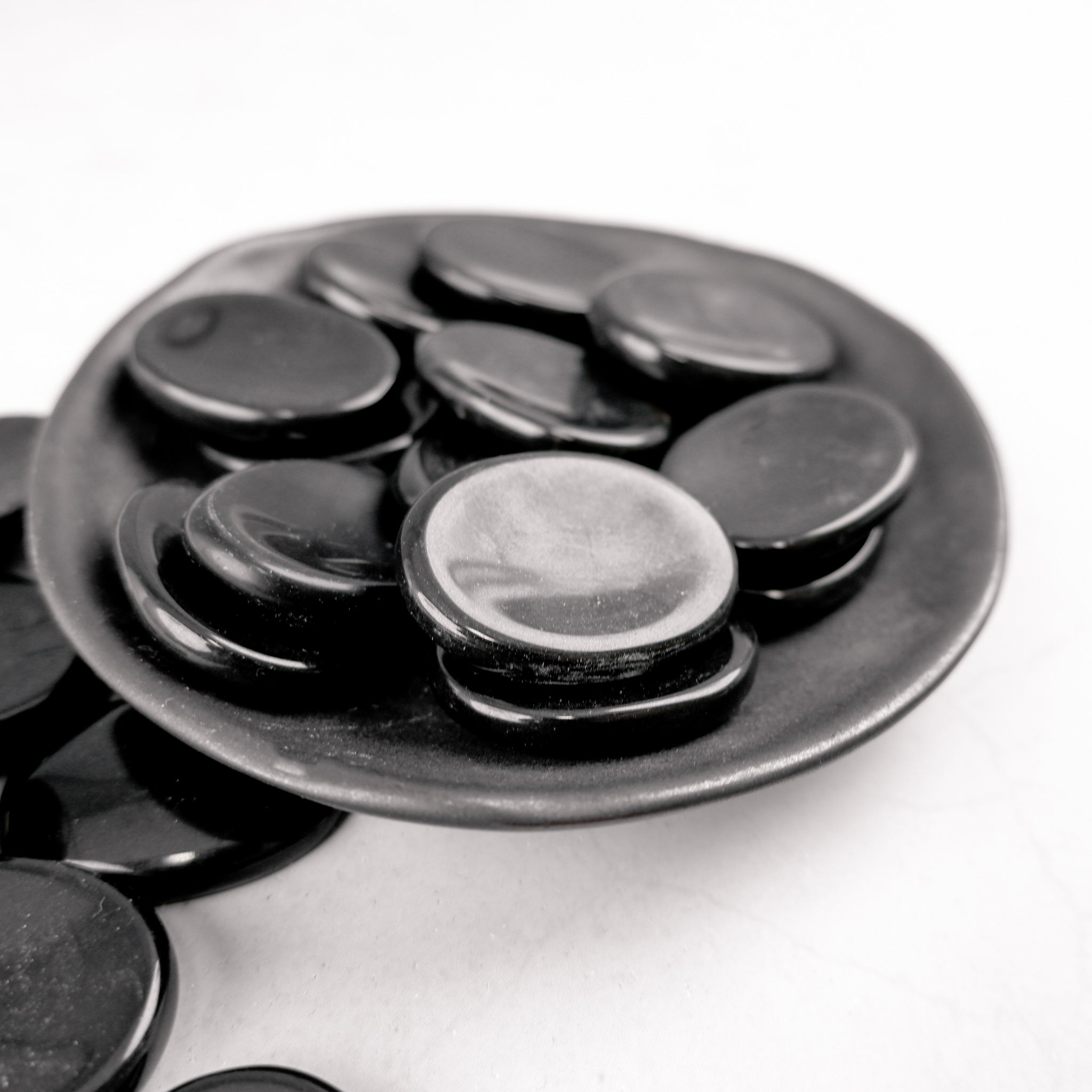 Black Jasper worry stone from Noctis Studio, smooth polished gemstone with calming black and gray tones, handheld for stress relief.