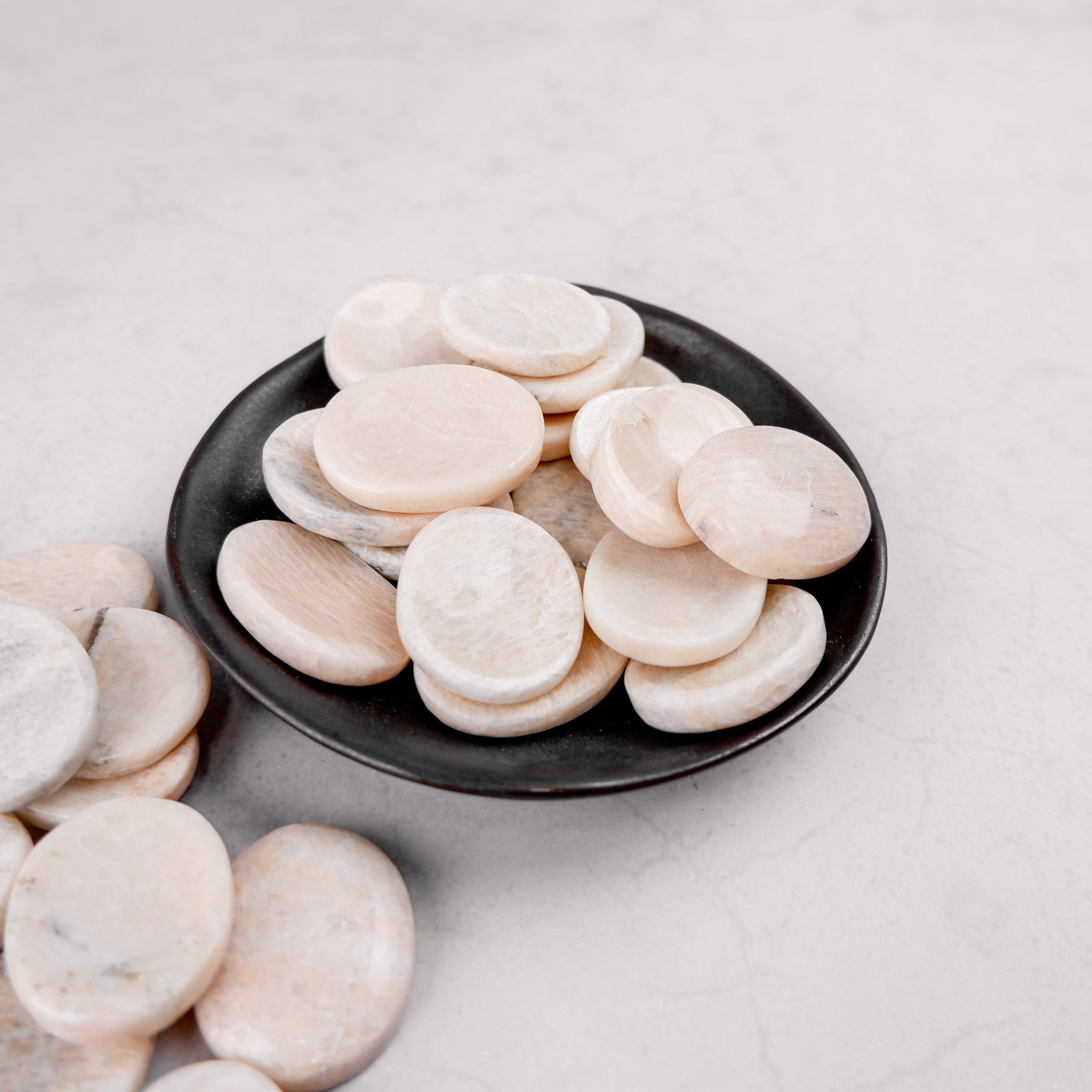 Cream moonstone worry stone by Noctis Studio showing smooth, polished oval shape with gentle cream and iridescent sheen.