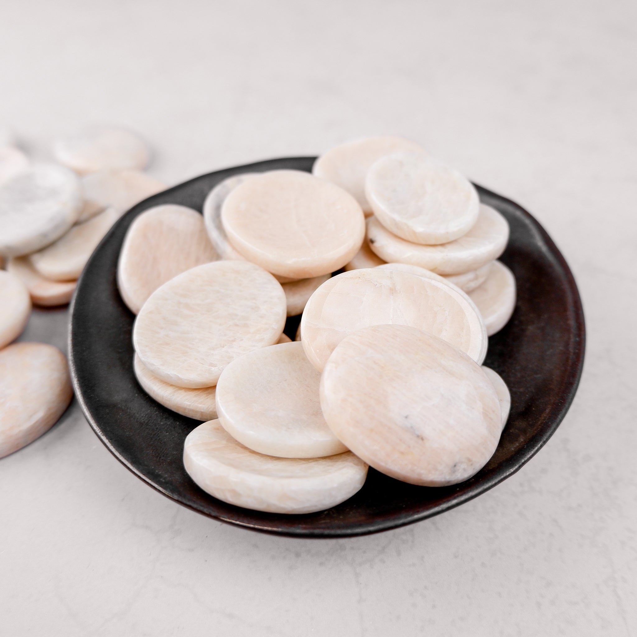 Cream moonstone worry stone by Noctis Studio, smooth polished gemstone with calming, pearly finish for stress relief and meditation.