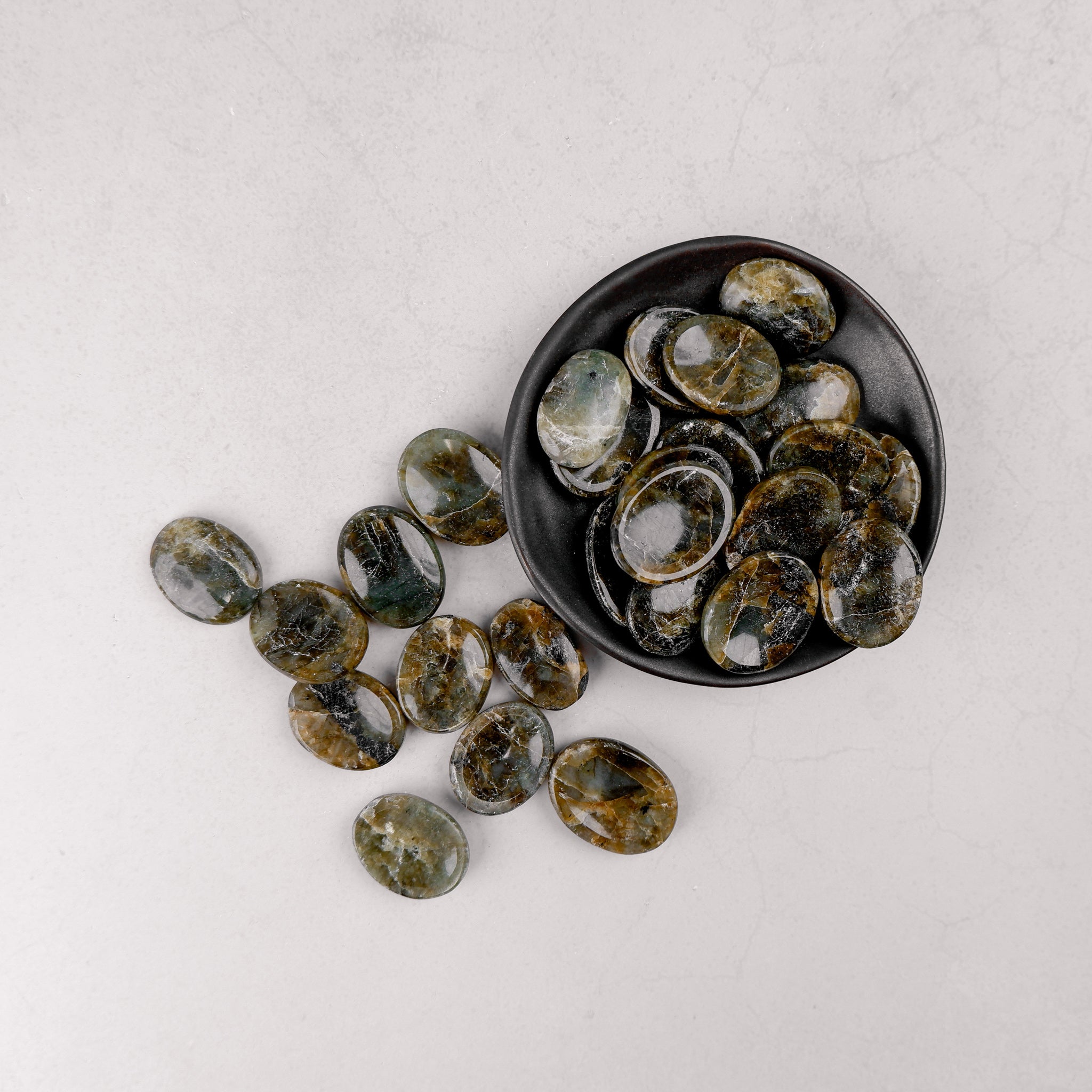 Labradorite worry stone from Noctis Studio showing iridescent gray-blue hues and smooth, polished surface for stress relief.
