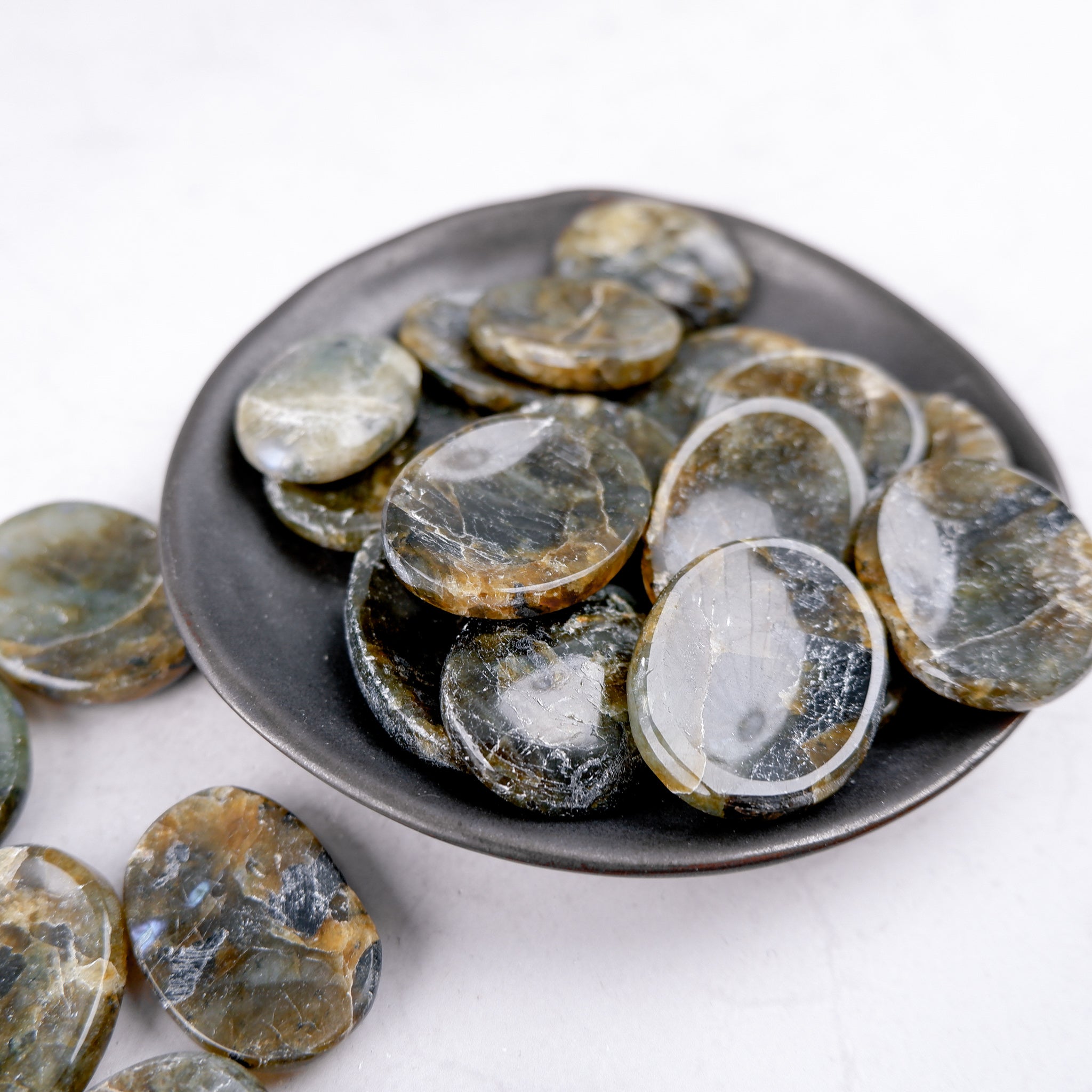 Labradorite worry stone from Noctis Studio, smooth polished gemstone for stress relief and meditation.