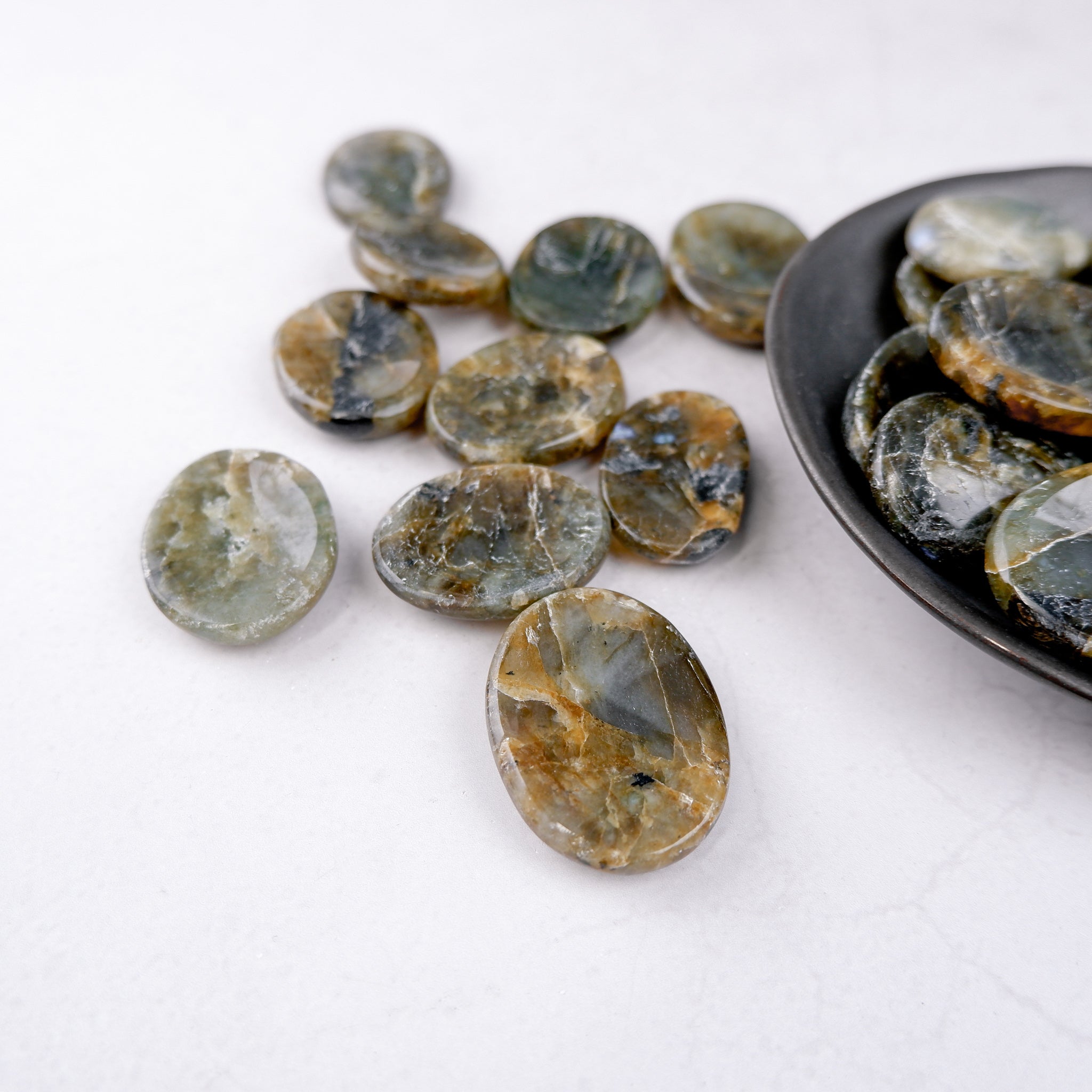 Labradorite worry stone from Noctis Studio, smooth polished gemstone with iridescent blue and green hues for stress relief.