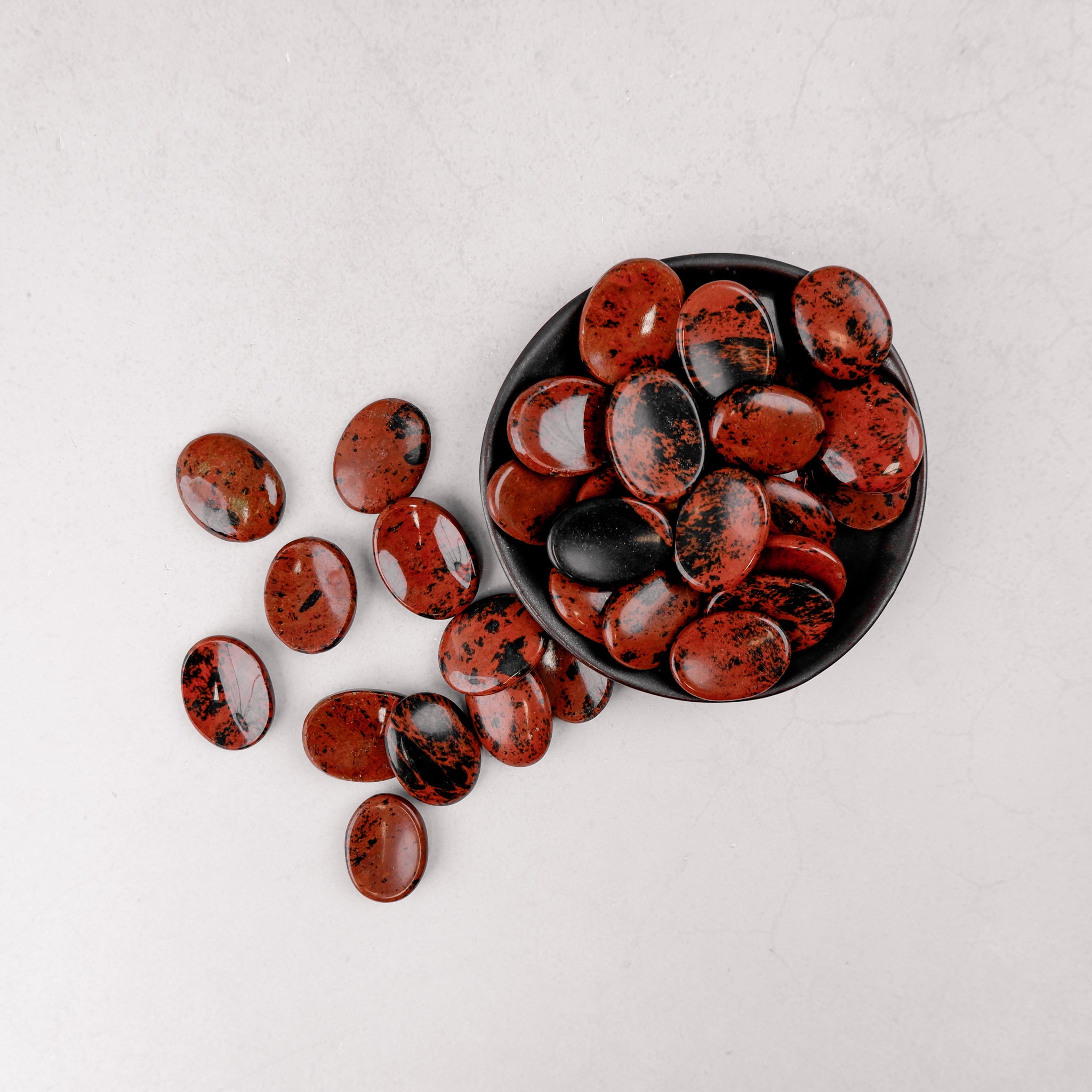 Mahogany Obsidian worry stone from Noctis Studio, smooth polished gemstone for calming hand-held stress relief.
