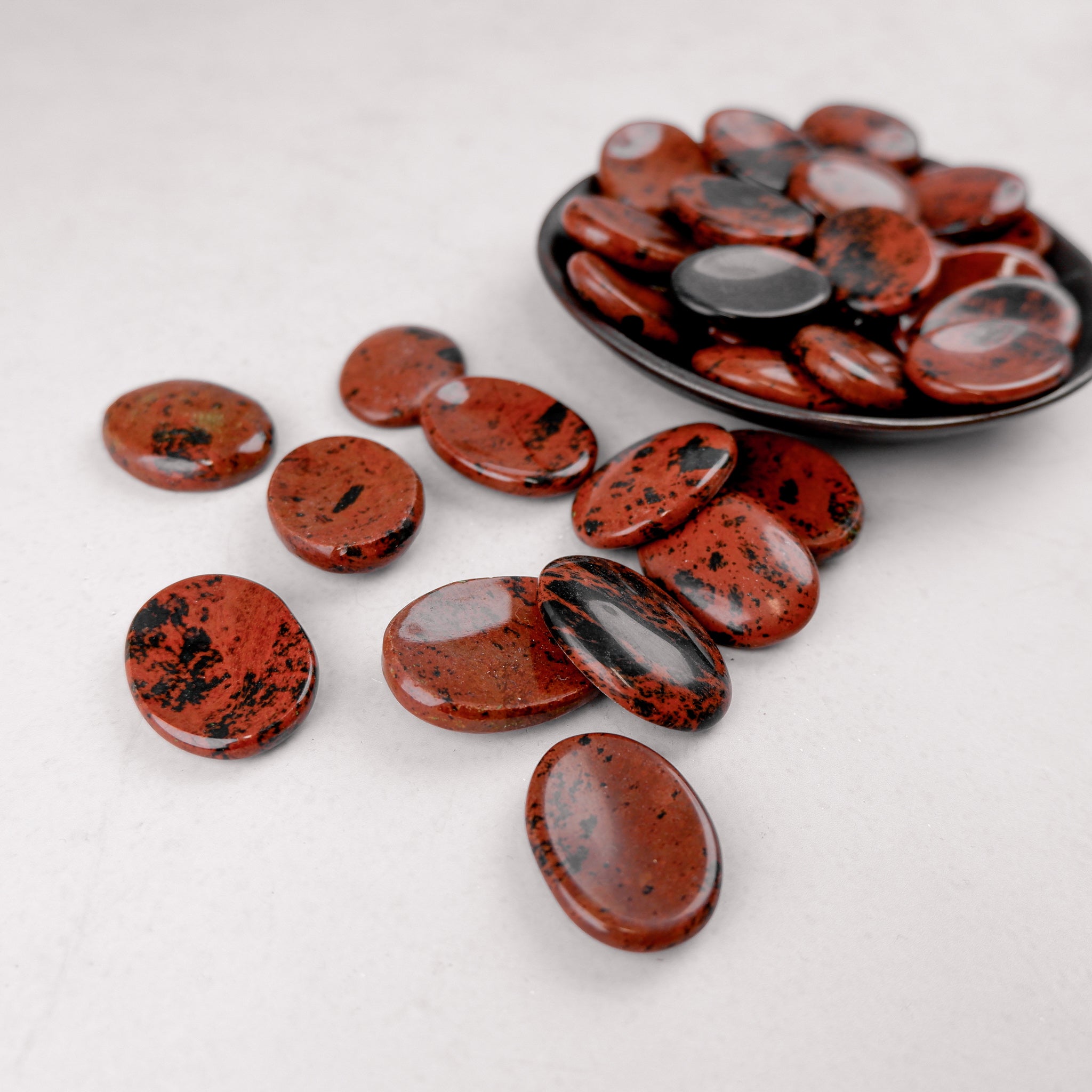 Mahogany Obsidian worry stone from Noctis Studio, smooth polished gemstone for meditation and stress relief.