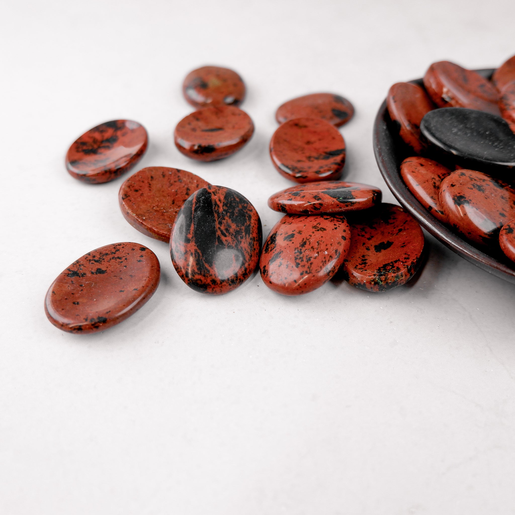Mahogany Obsidian worry stone from Noctis Studio, smooth polished gemstone for stress relief and meditation.