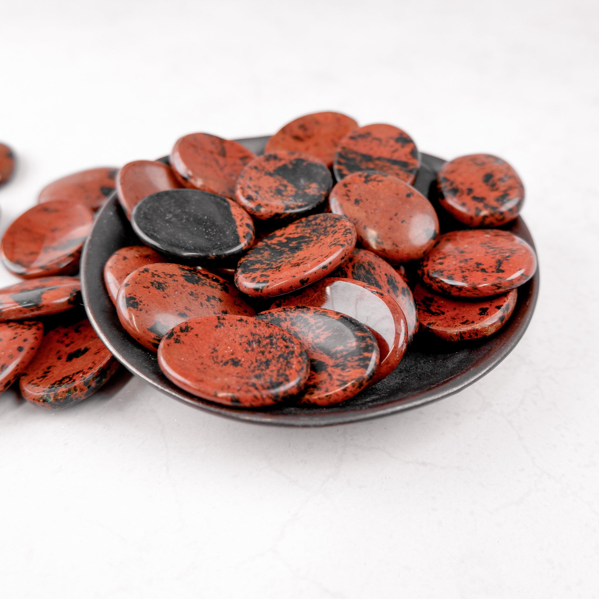 Mahogany Obsidian worry stone from Noctis Studio, polished smooth gemstone for meditation and stress relief.