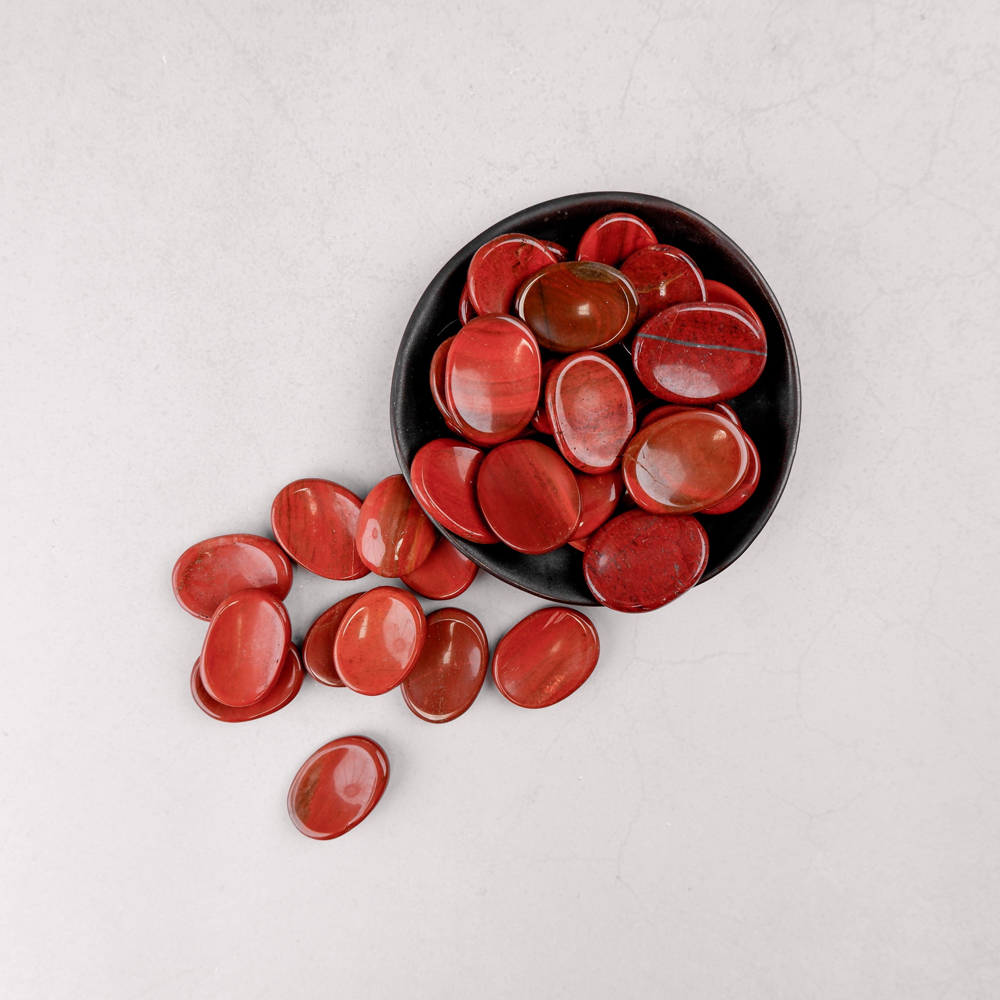 Red Jasper worry stone from Noctis Studio, smooth polished gemstone for stress relief and meditation.