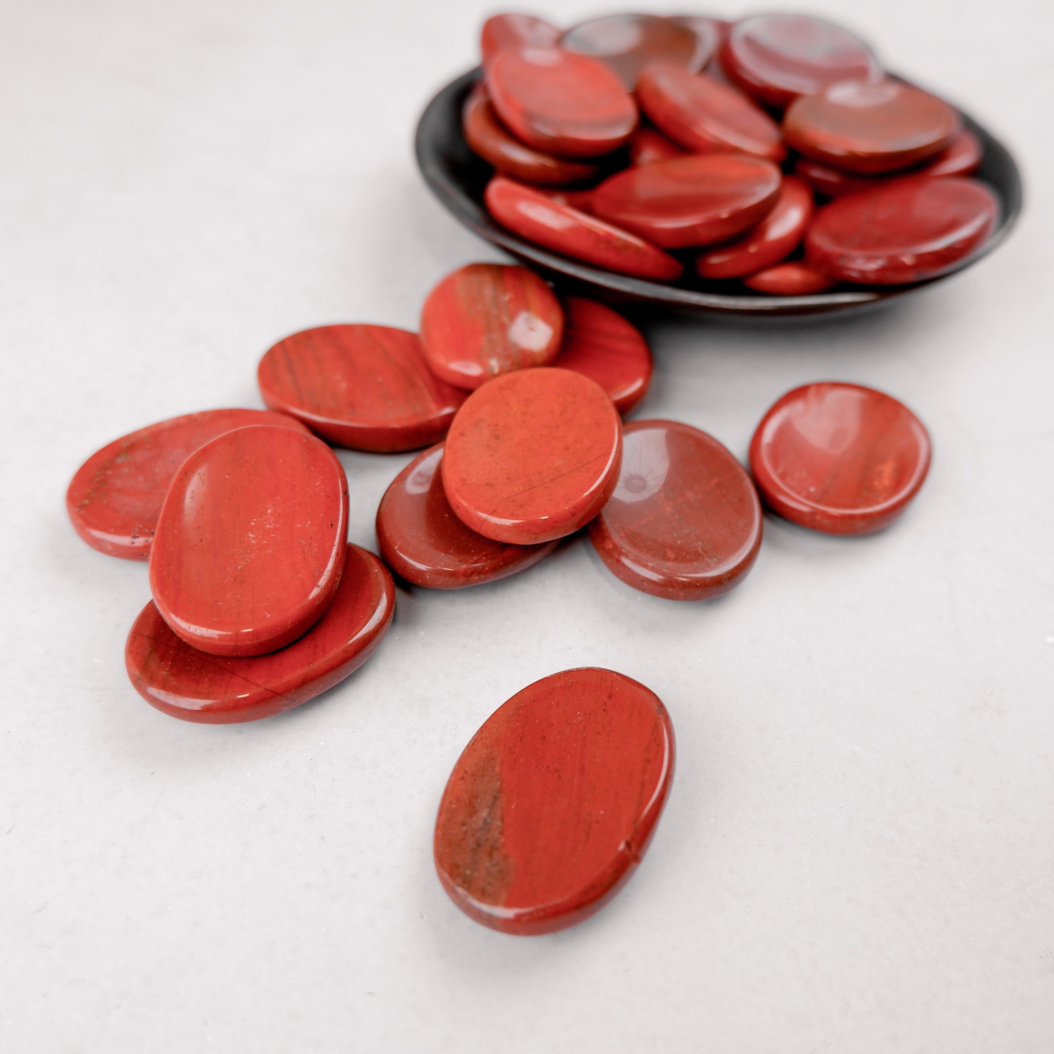 Red Jasper worry stone from Noctis Studio, smooth polished gemstone for calming and stress relief.