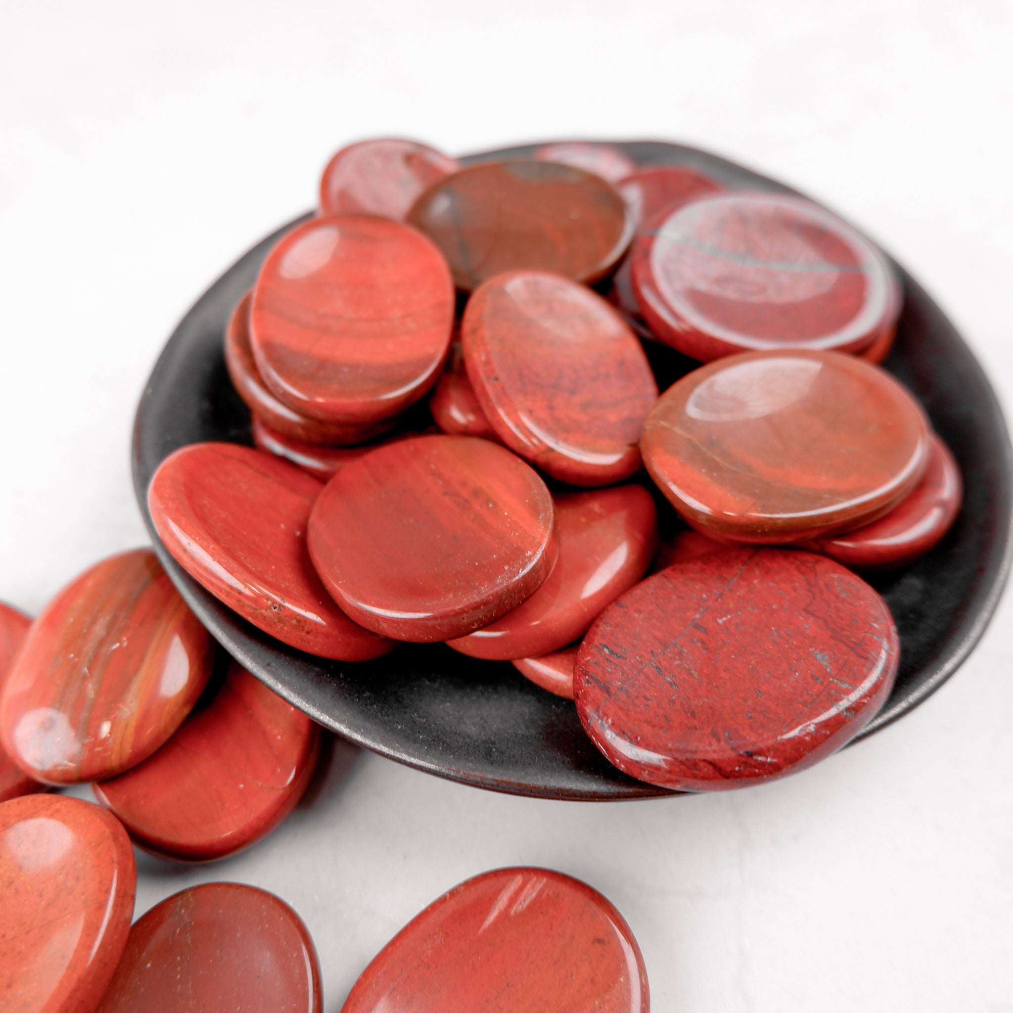 Red Jasper worry stone from Noctis Studio, smooth polished gemstone for stress relief and meditation.