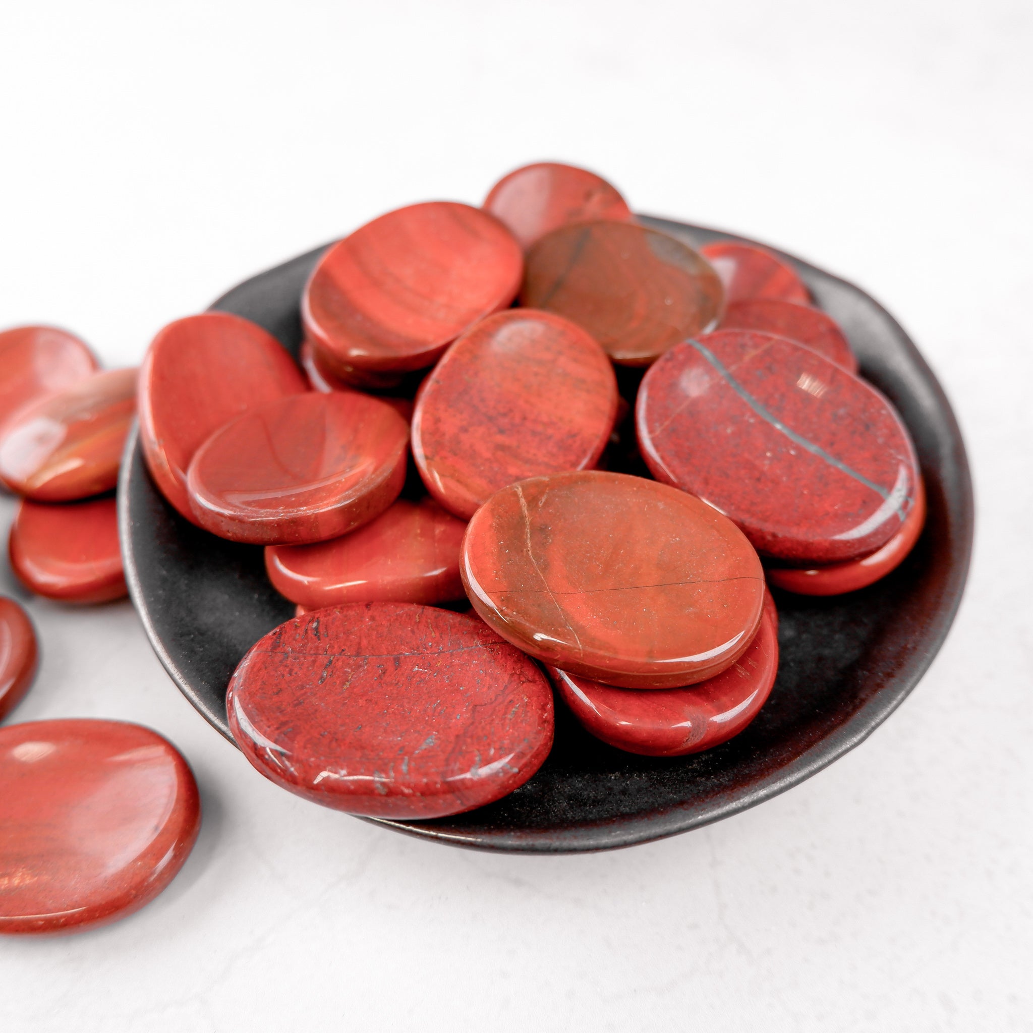 Red Jasper worry stone from Noctis Studio featuring smooth, polished red jasper with a rounded shape for stress relief.