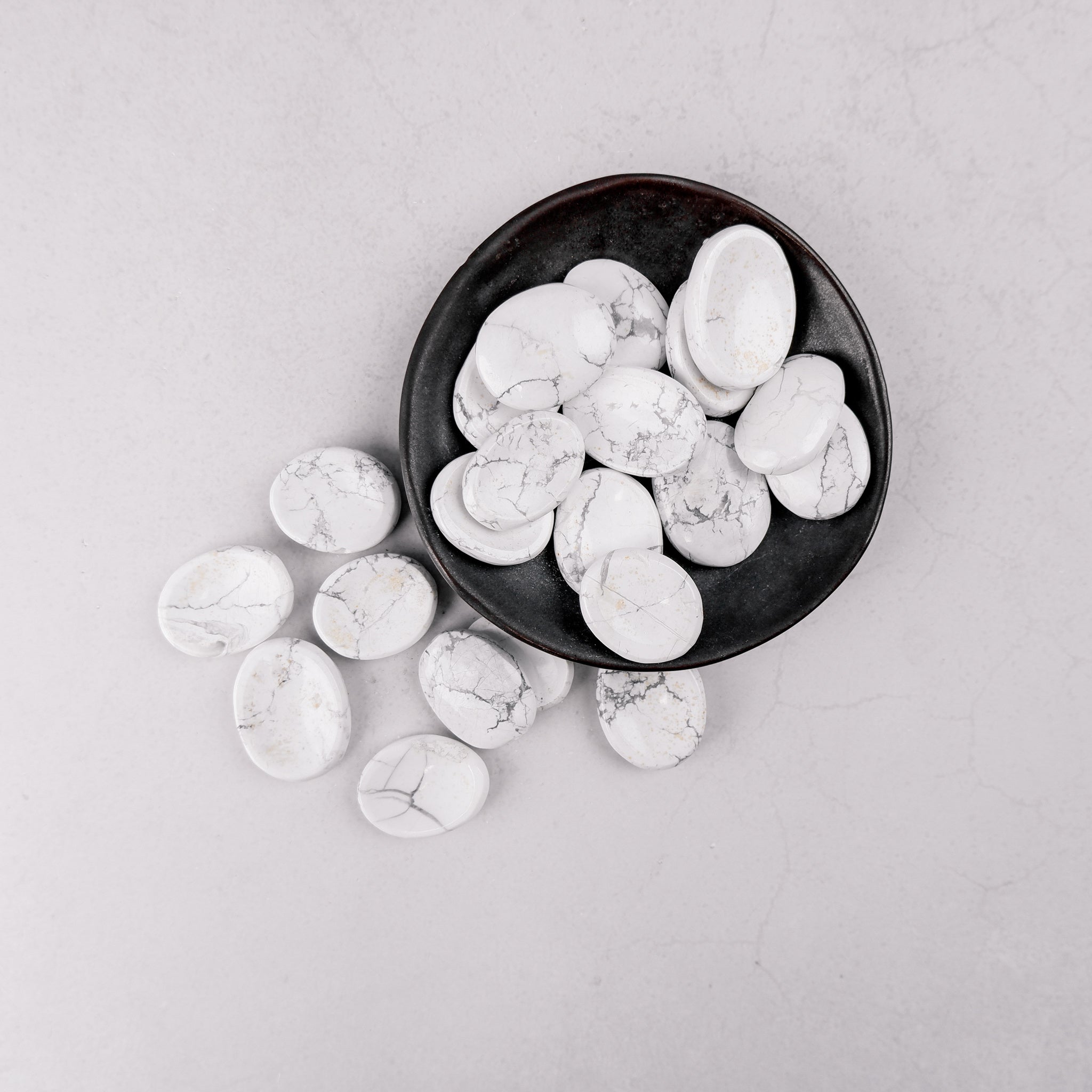White Howlite worry stone from Noctis Studio, smooth polished gemstone for stress relief and meditation.