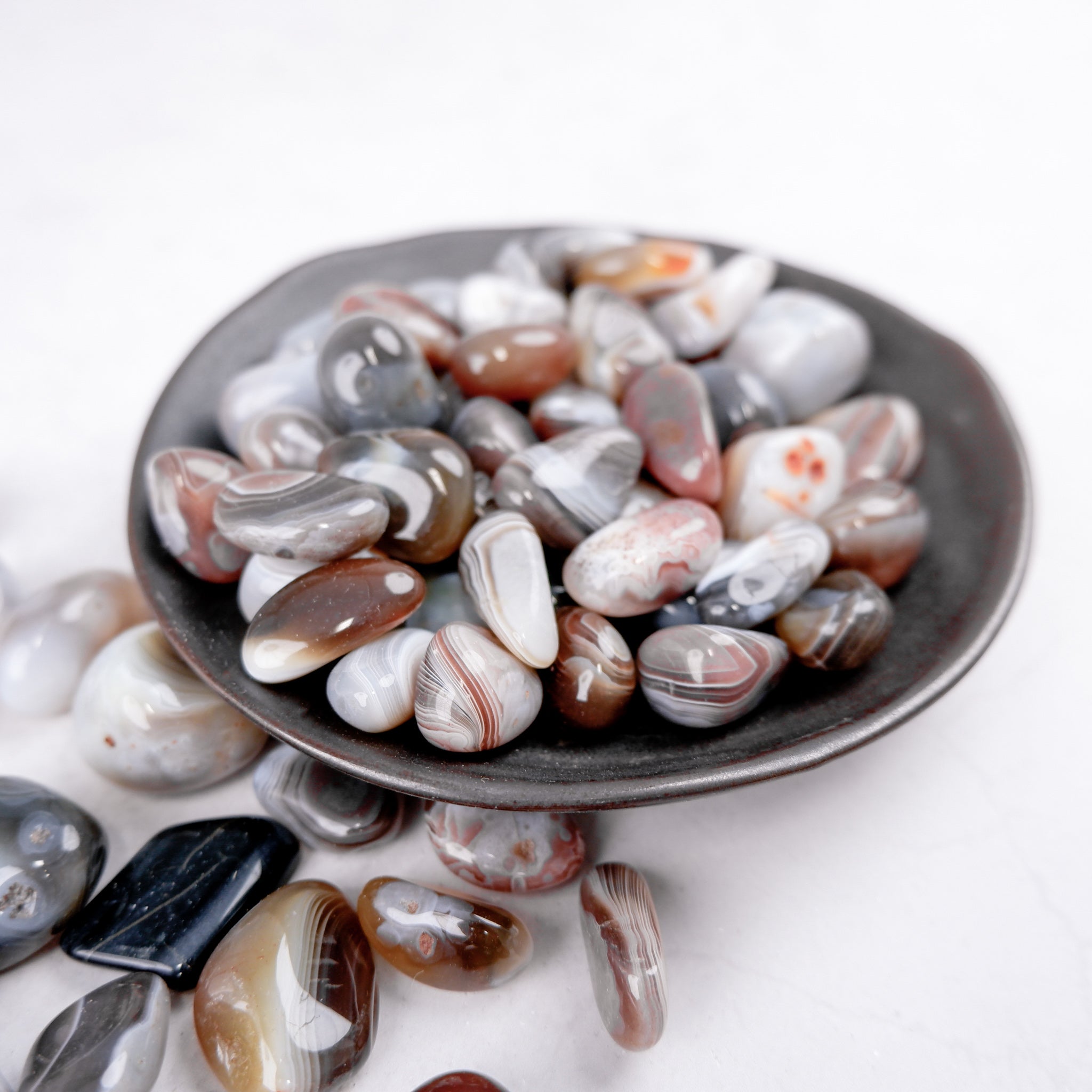 Botswana Agate tumble stone from Noctis Studio, polished gemstone with unique banding and natural earthy tones.