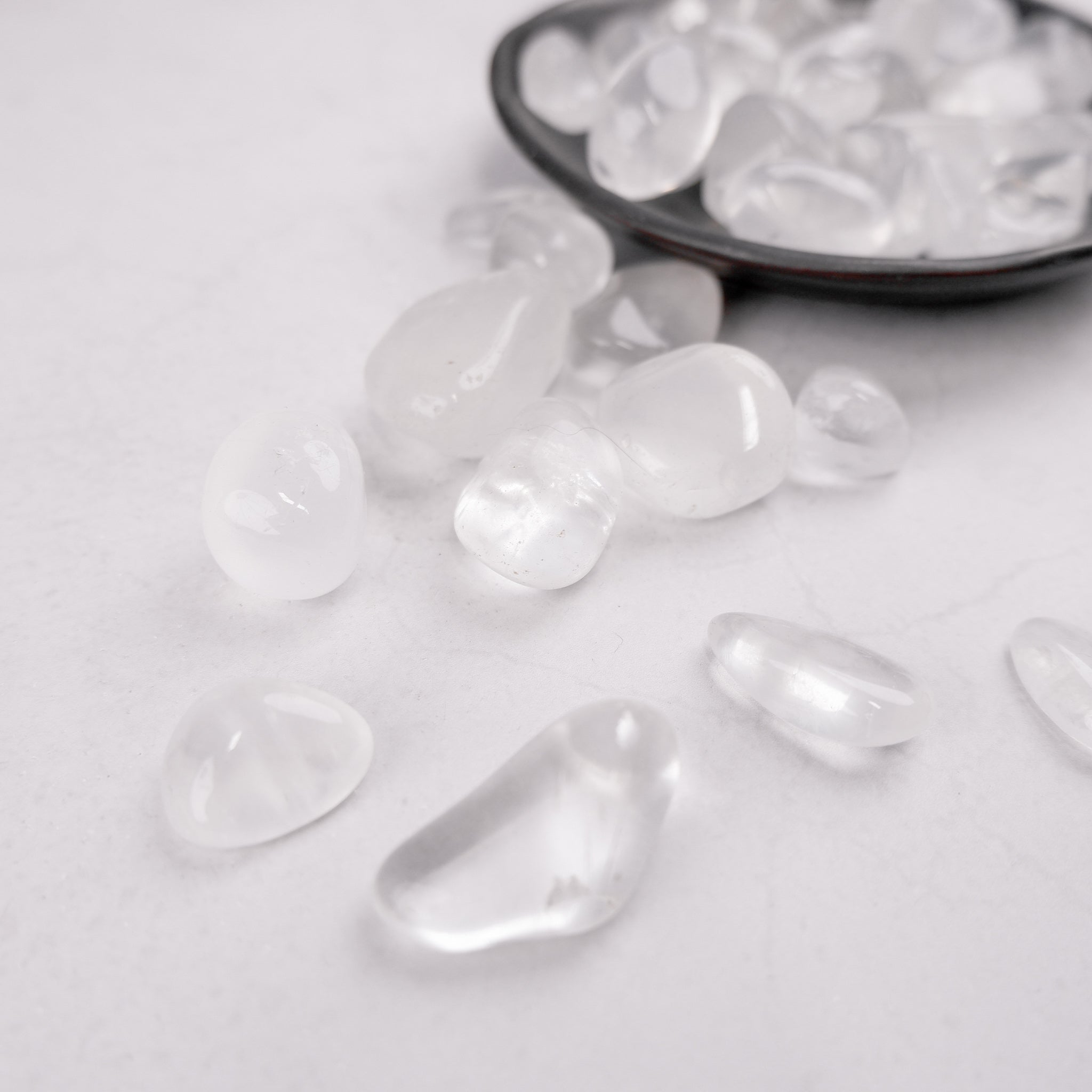 Noctis Studio Girasol tumble stone showing its polished, light yellow and translucent mineral surface on a white background.