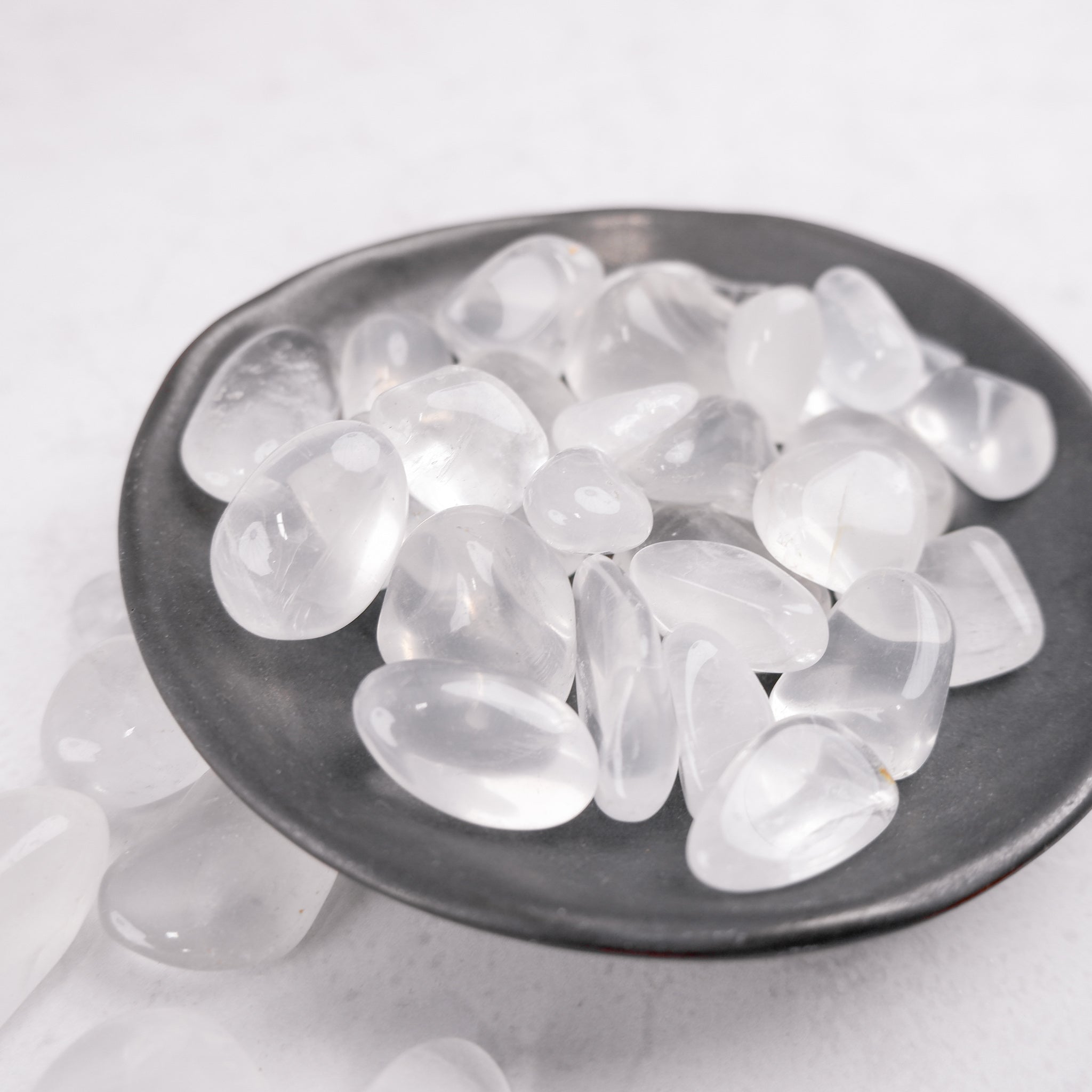 Noctis Studio Girasol tumble stone on display, smooth polished mineral with a soft, translucent yellow appearance.