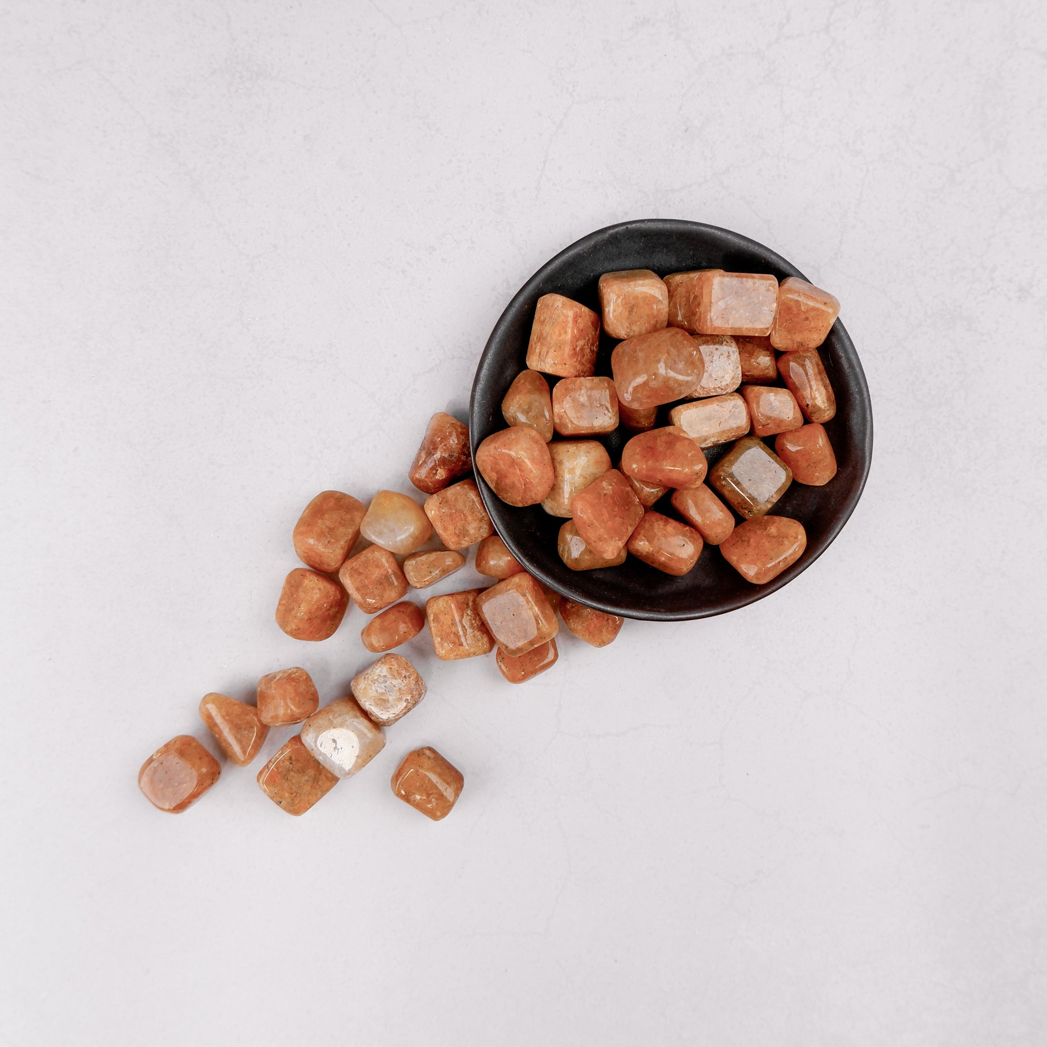 Golden Quartz tumble stone from Noctis Studio, polished gemstone with a warm golden hue and smooth, rounded shape.