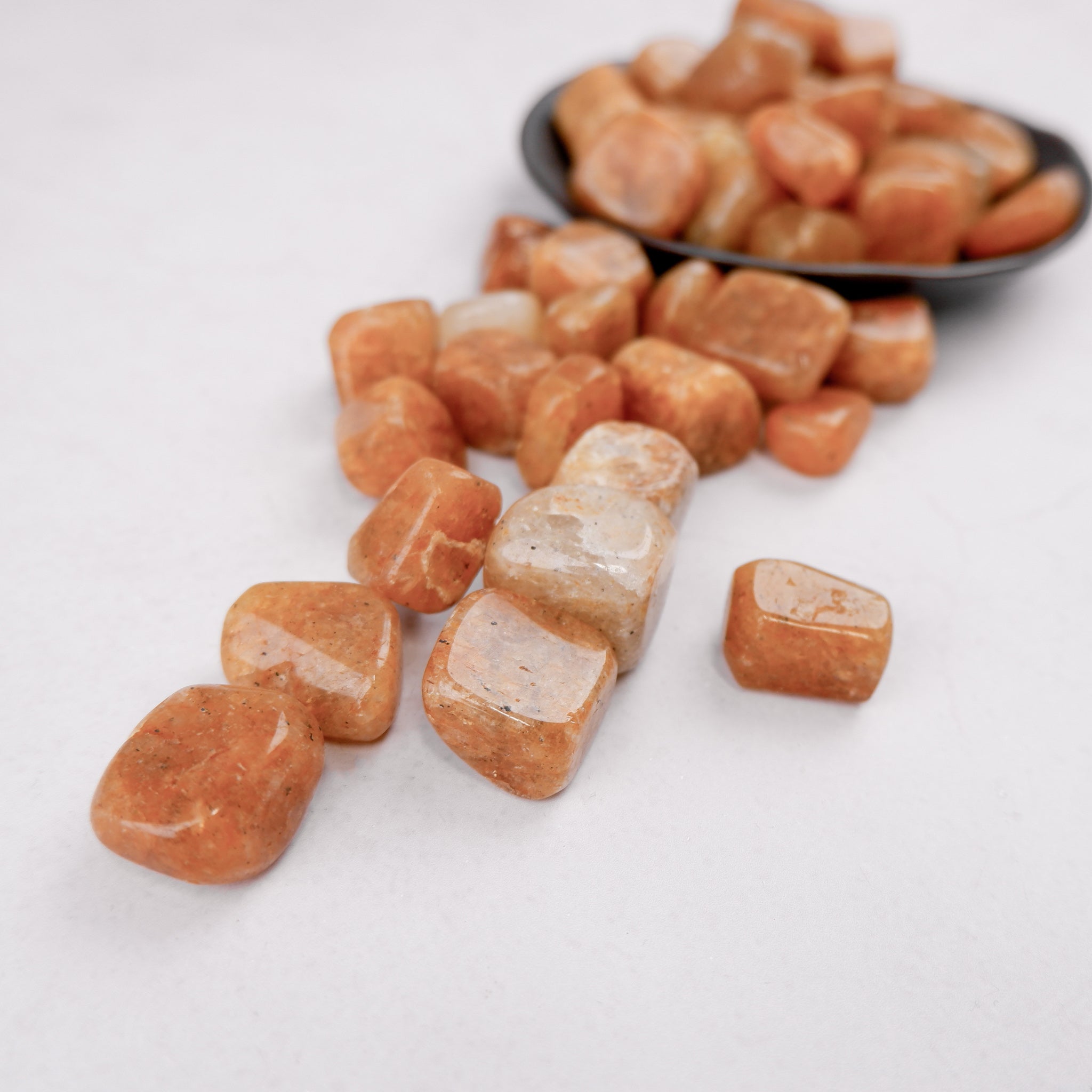 Golden Quartz tumble stone from Noctis Studio, smooth polished healing gemstone with a golden hue and natural crystal formation.