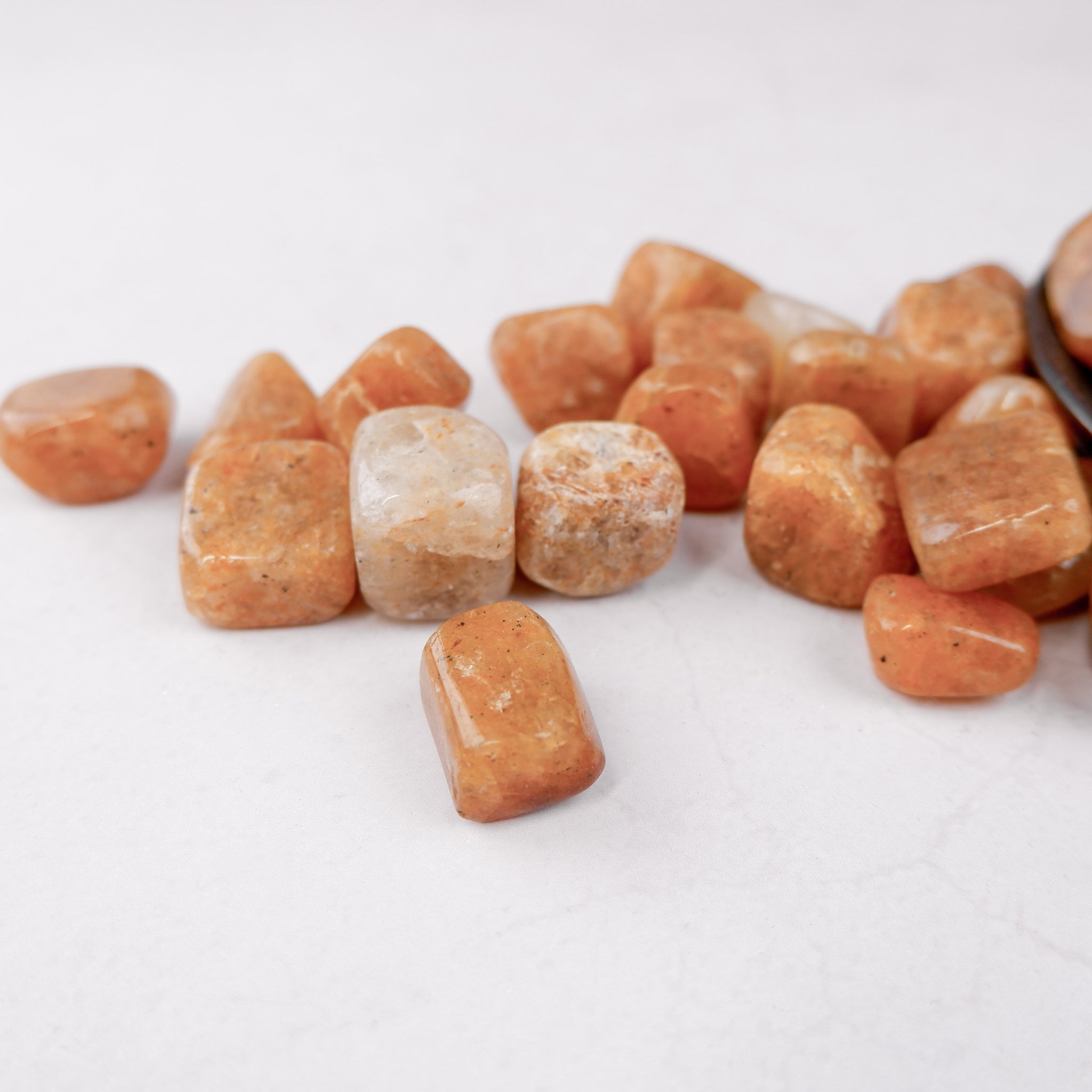 Golden Quartz tumble stone from Noctis Studio, showing polished yellow gemstone with smooth rounded edges and natural crystal appearance.