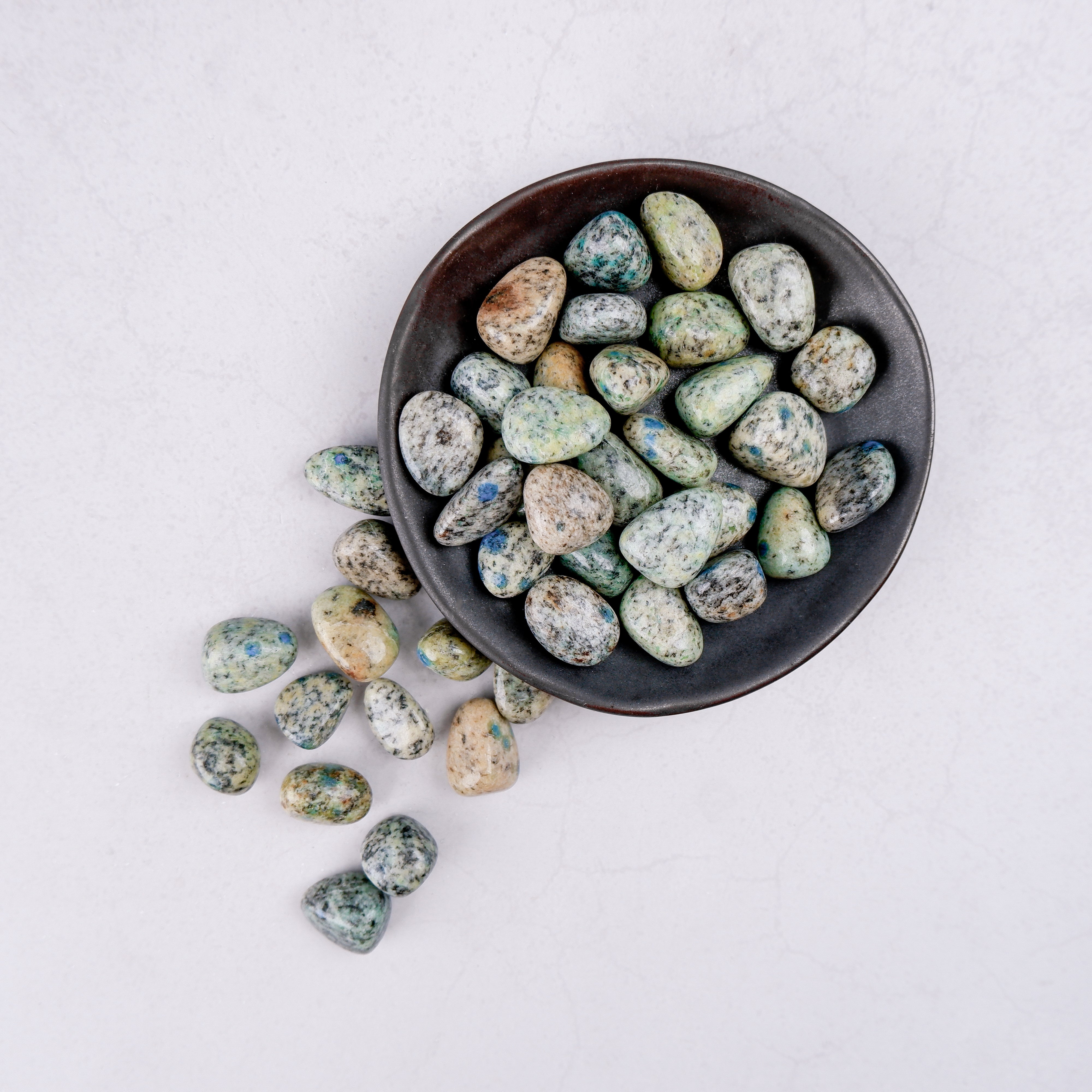 Noctis Studio K2 Tumble Stone showing smooth, polished blue-green mineral with natural patterns and rounded shape.
