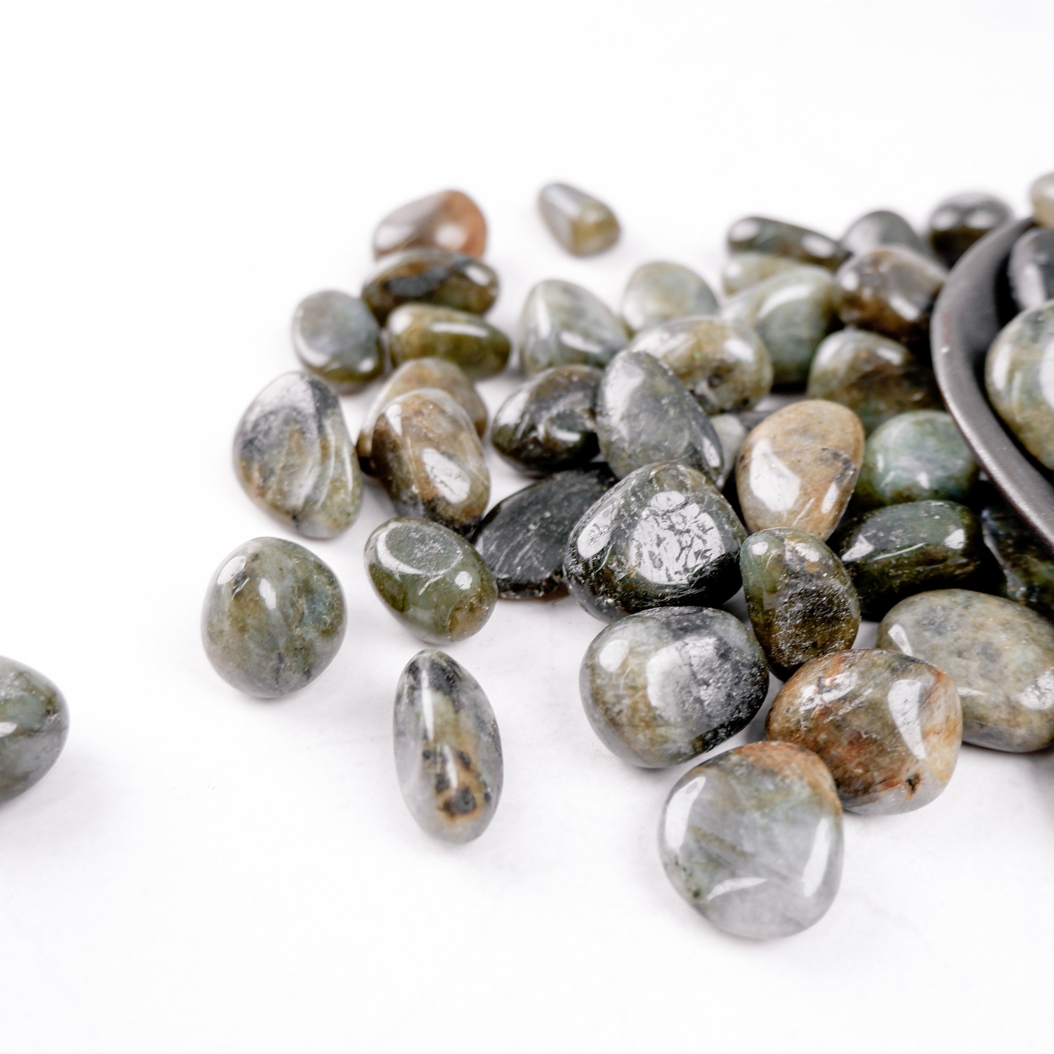 Labradorite tumble stone from Noctis Studio showing iridescent gray and blue hues with polished smooth surface.