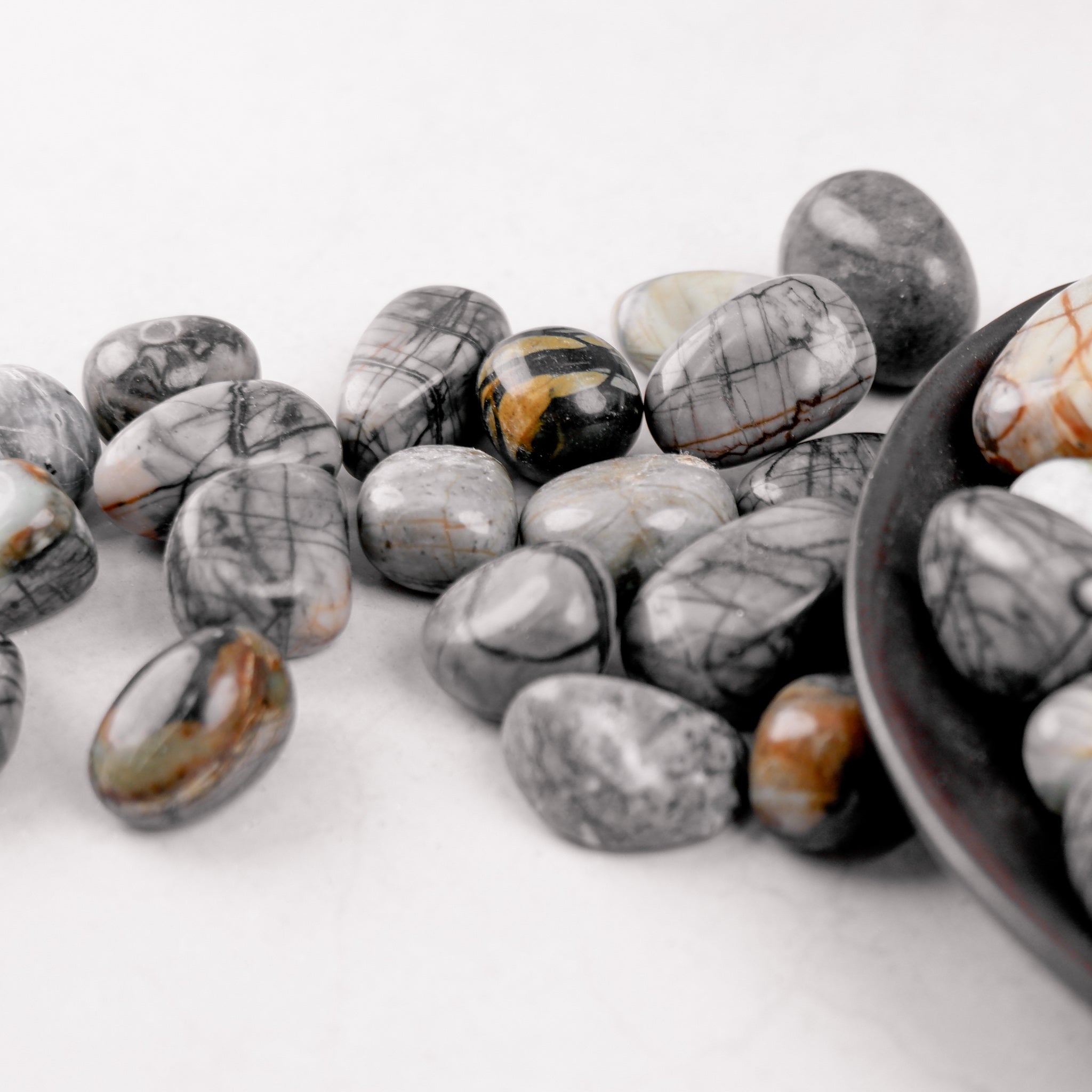 Noctis Studio Picasso Jasper tumble stone showing vibrant, patterned mineral with polished, smooth surface for decorative use.