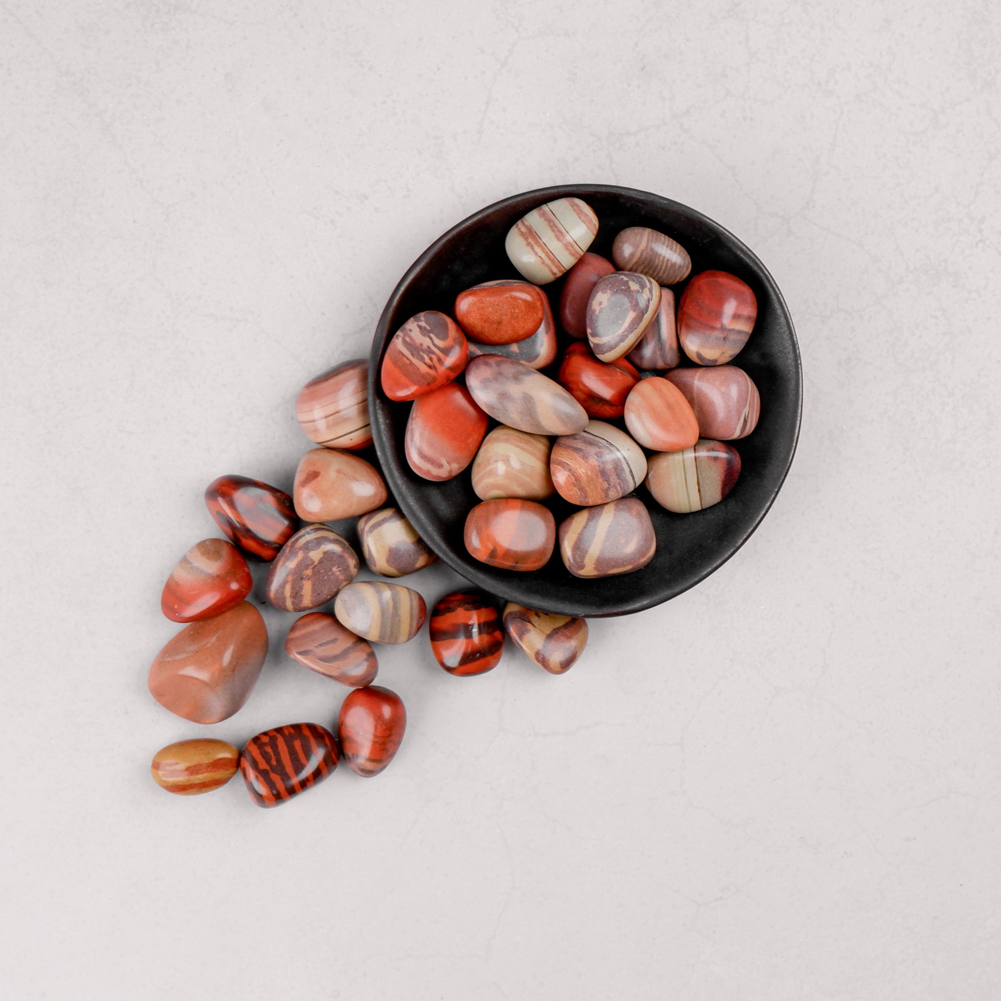 Noctis Studio Print Stone Tumble Stone showcasing a smooth, polished stone with intricate print design on a neutral background.