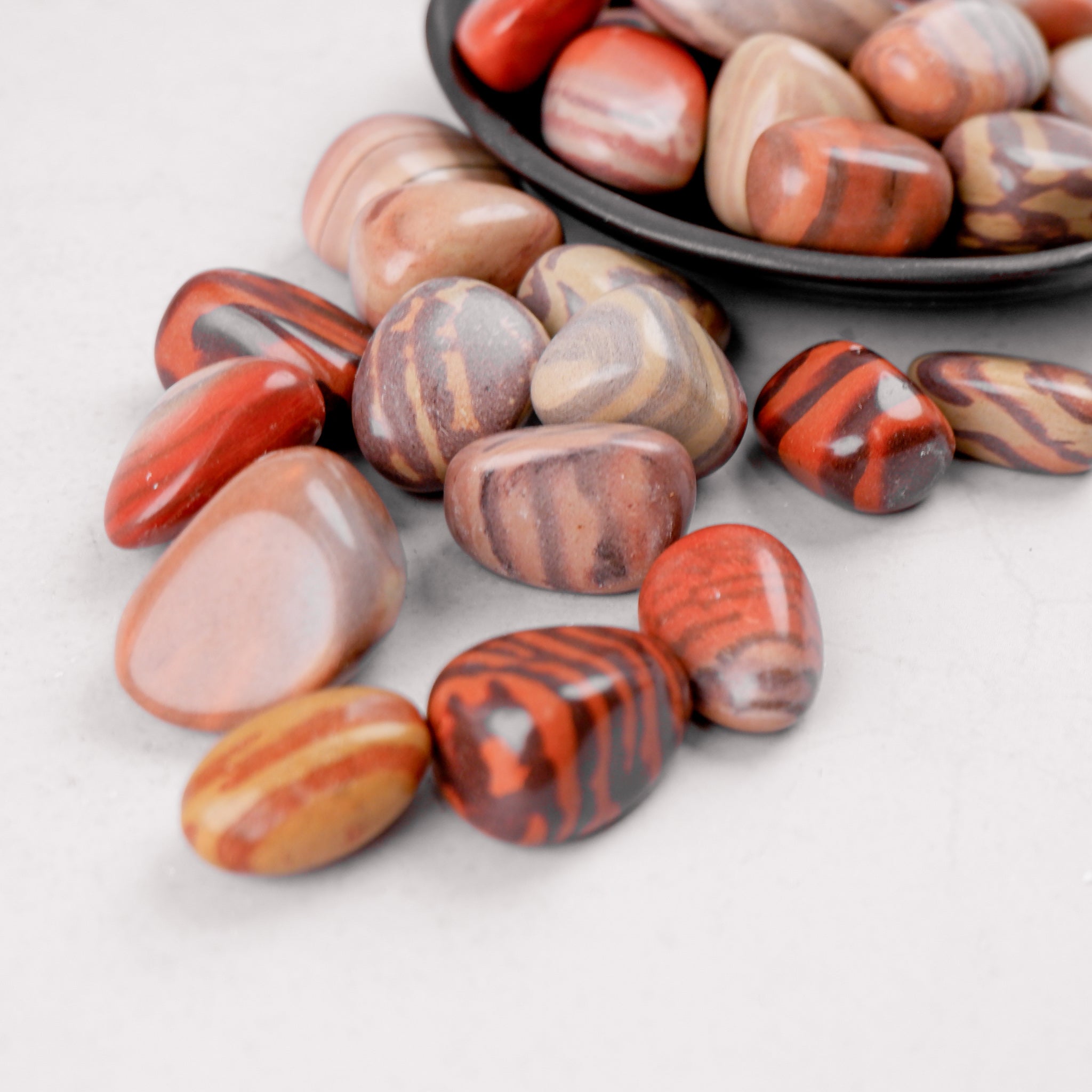 Noctis Studio Print Stone tumble stone with intricate print design, smooth surface, and natural stone texture.