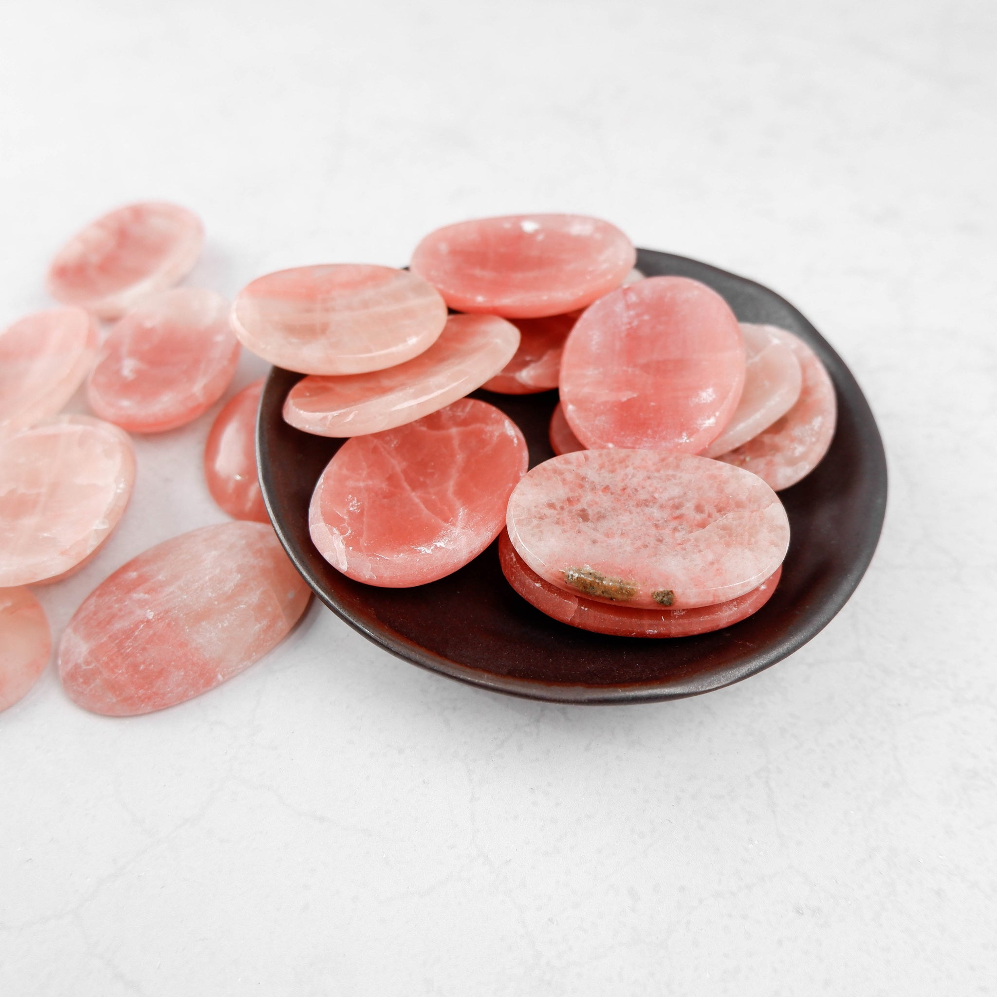 Rose Calcite worry stone from Noctis Studio with smooth, polished surface and soft pink color, ideal for calming and stress relief.