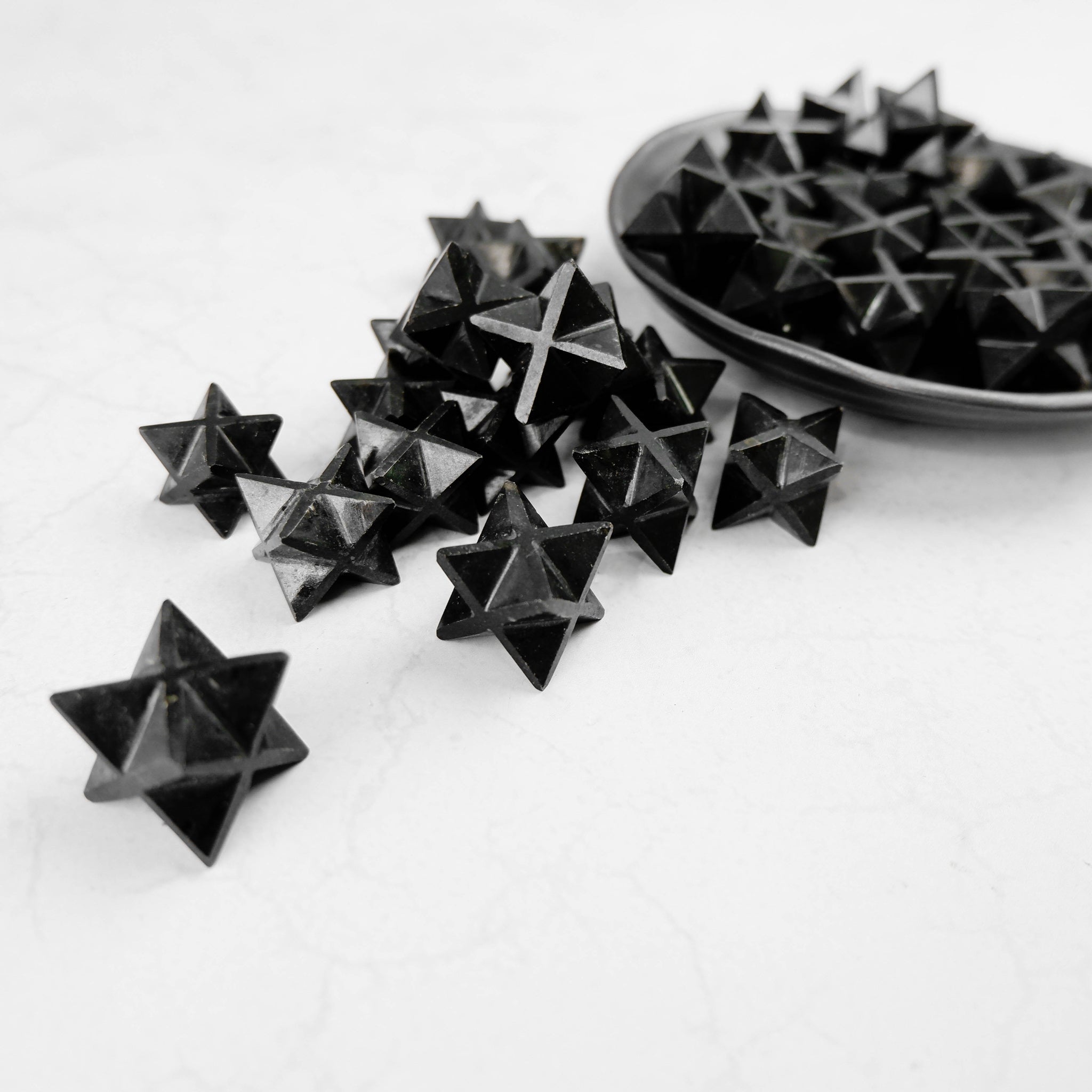 Black Tourmaline Star gemstone by Noctis Studio, featuring a polished star-shaped black mineral with a smooth surface.