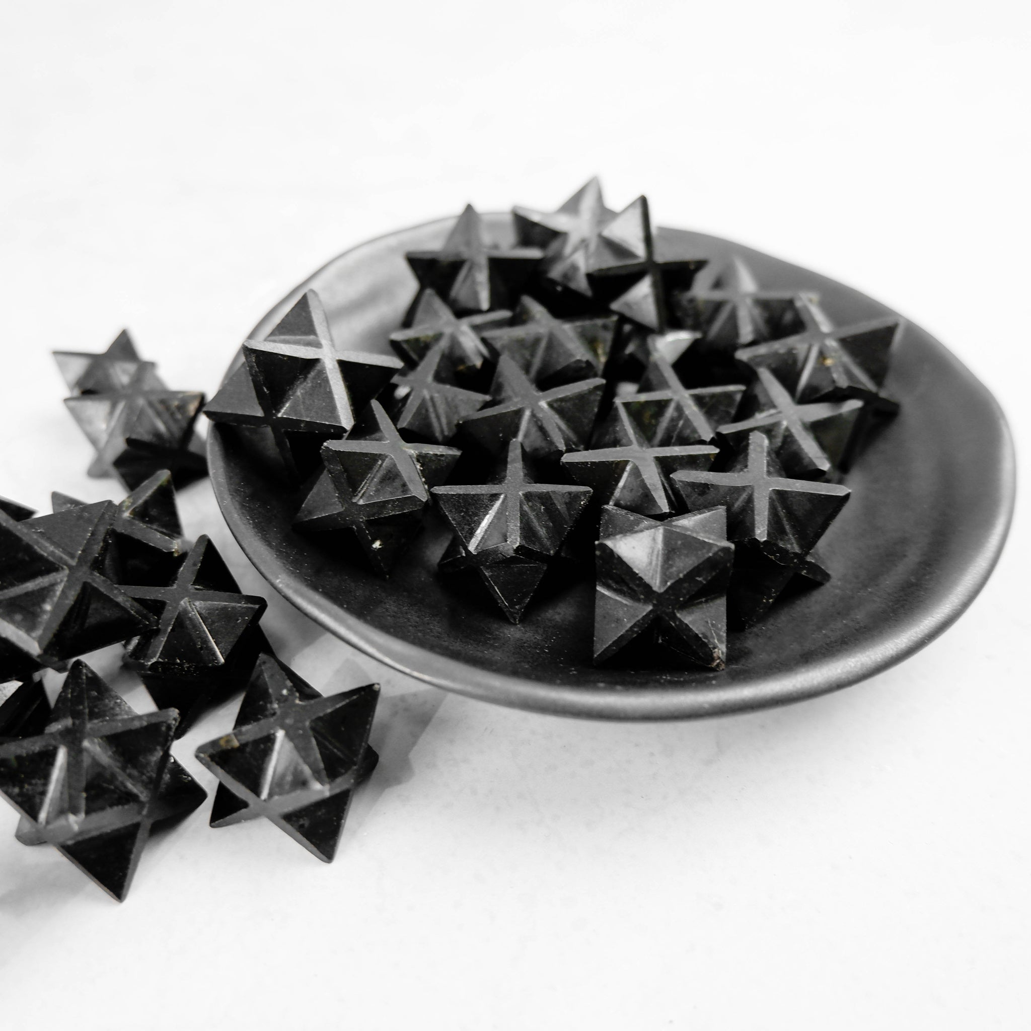 Black Tourmaline star sculpture by Noctis Studio, featuring a polished star-shaped mineral with a smooth finish.