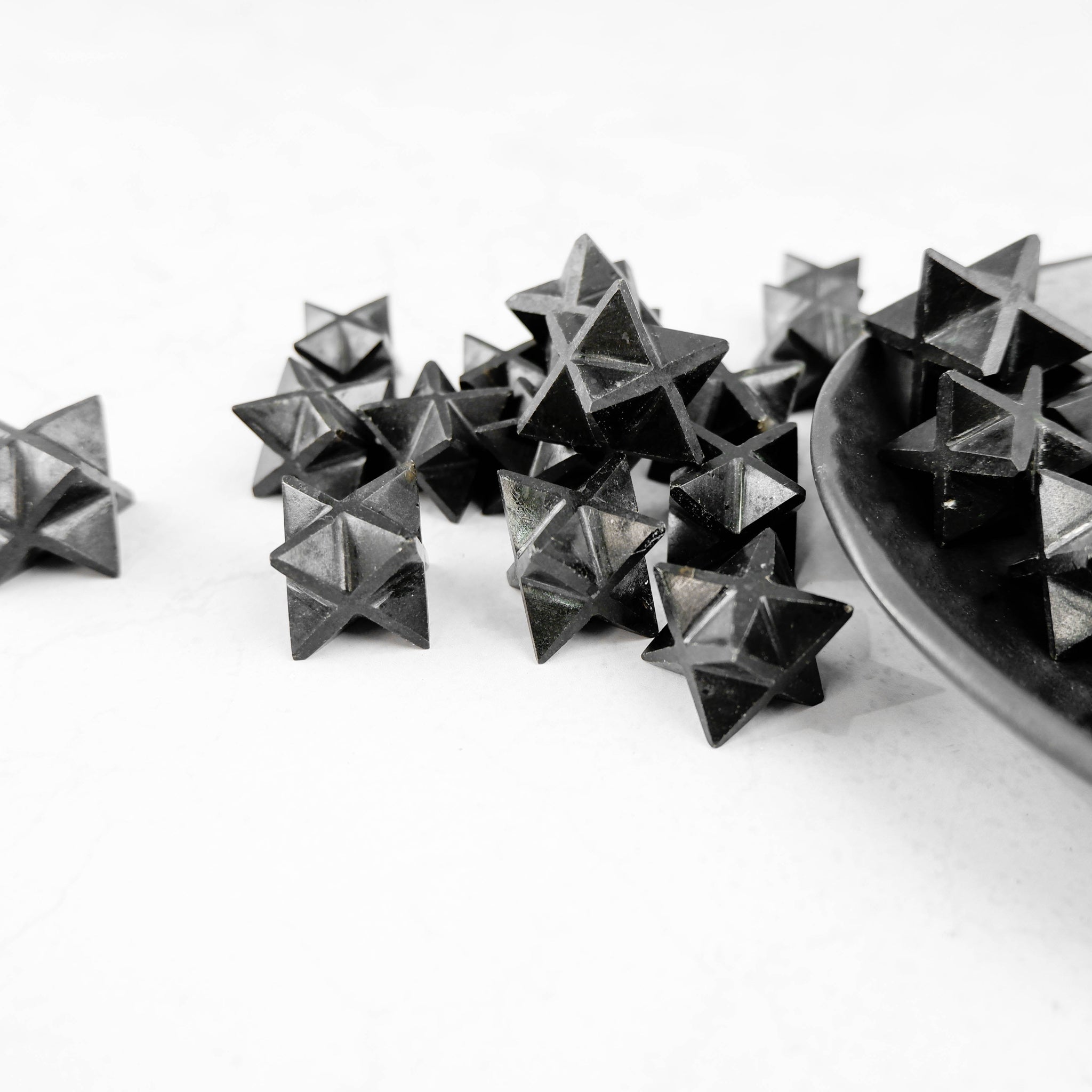 Black Tourmaline Star by Noctis Studio, a polished black stone shaped as a star with glossy surface and natural mineral textures.