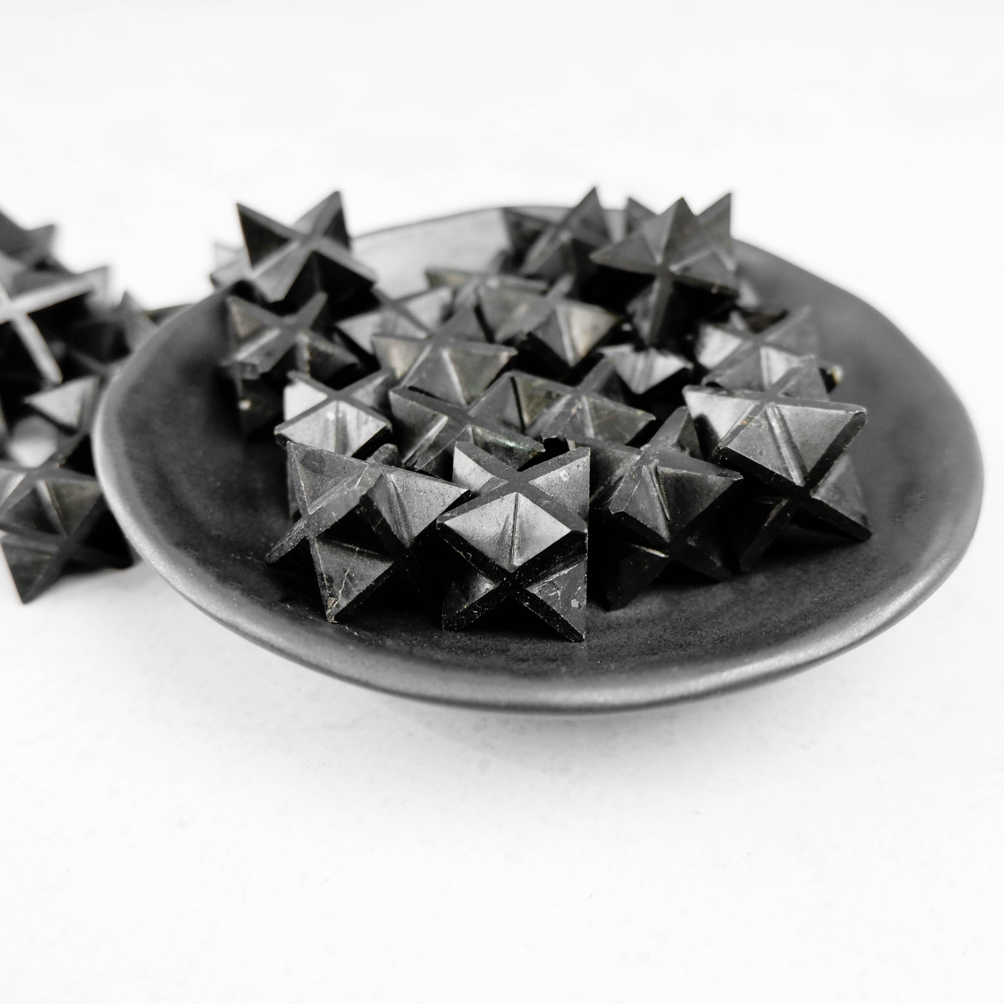 Black Tourmaline star sculpture by Noctis Studio, showcasing a polished star-shaped mineral with a smooth surface and natural black color.