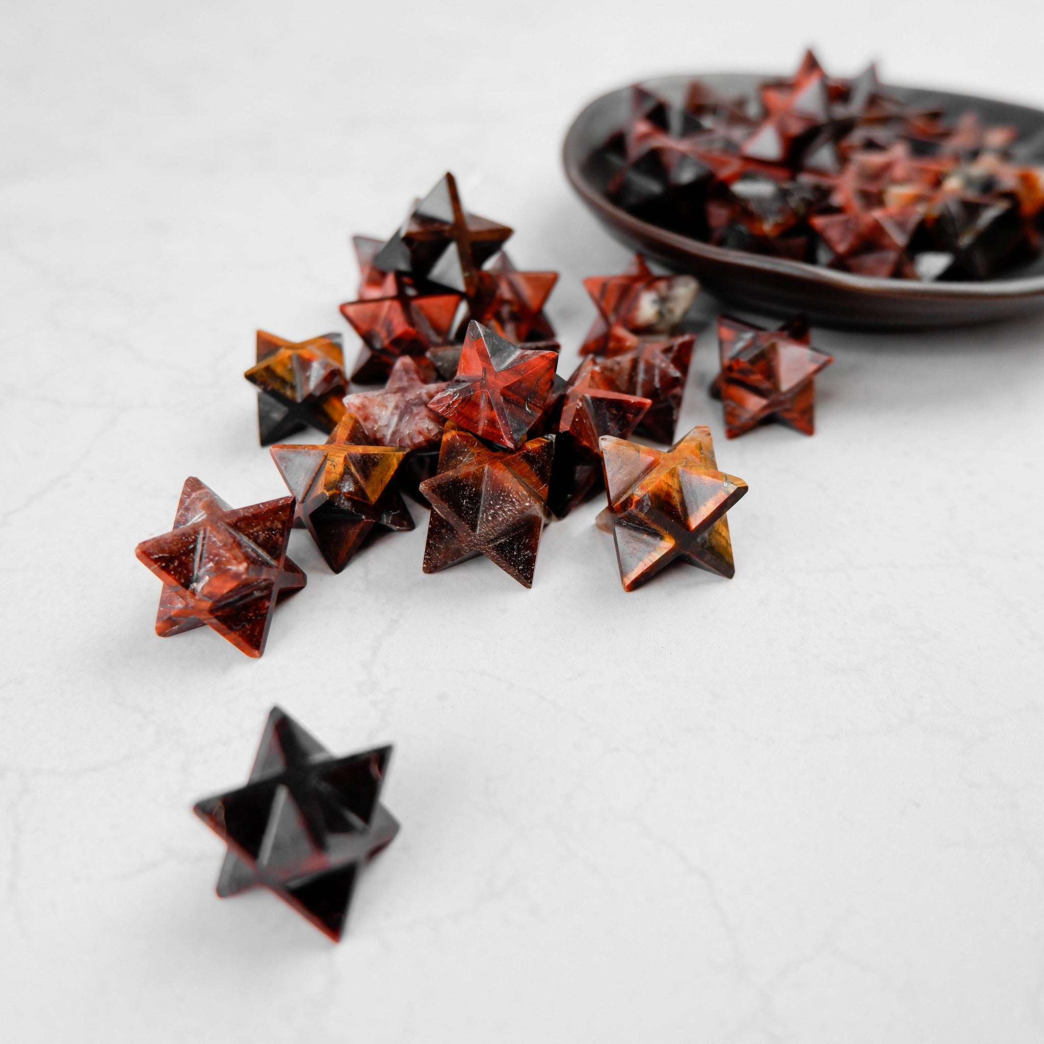Red Tigers Eye Star by Noctis Studio featuring a polished star-shaped gemstone with vibrant red and brown tiger eye patterns.