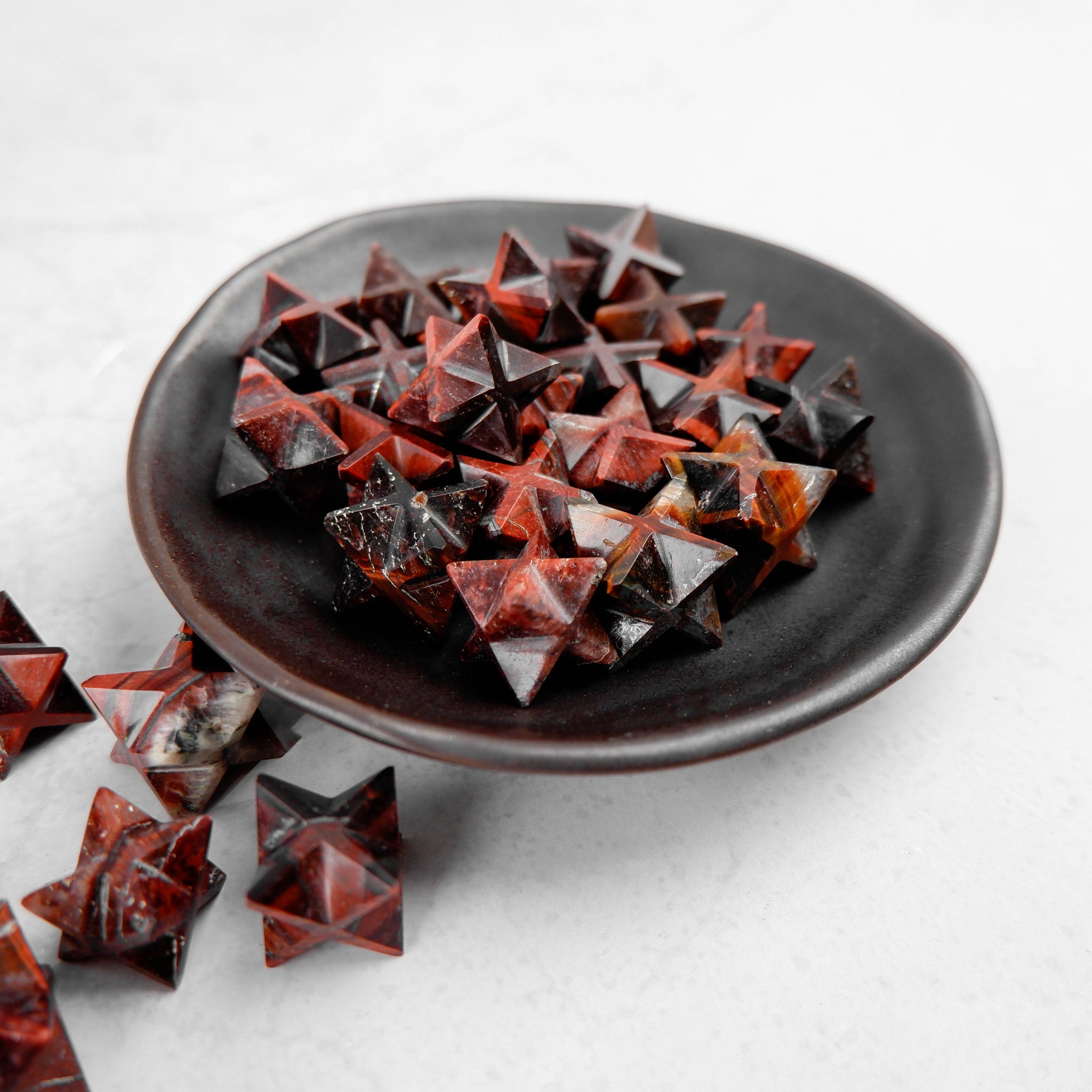 Red Tigers Eye Star pendant by Noctis Studio featuring a polished star-shaped gemstone with rich red and brown tones.